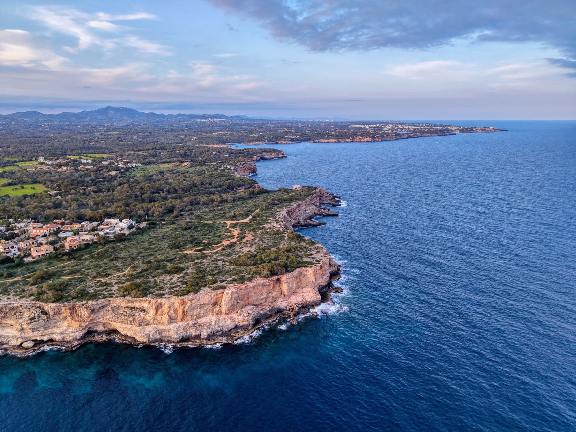 A breathtaking aerial view of the rugged coastline and azure waters of Mallorca, Spain.