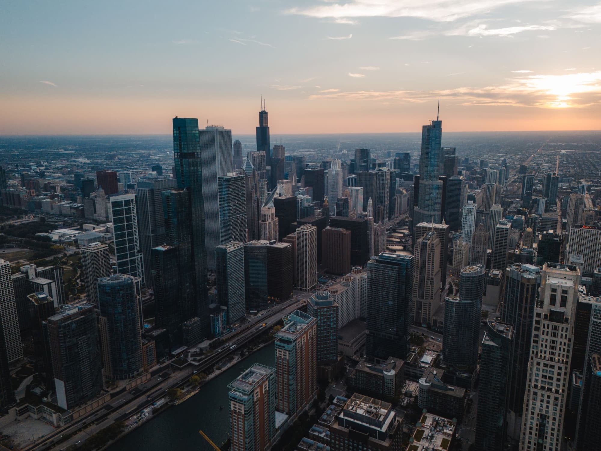 A breathtaking aerial shot of Chicago's skyline during sunset, showcasing the city's skyscrapers.