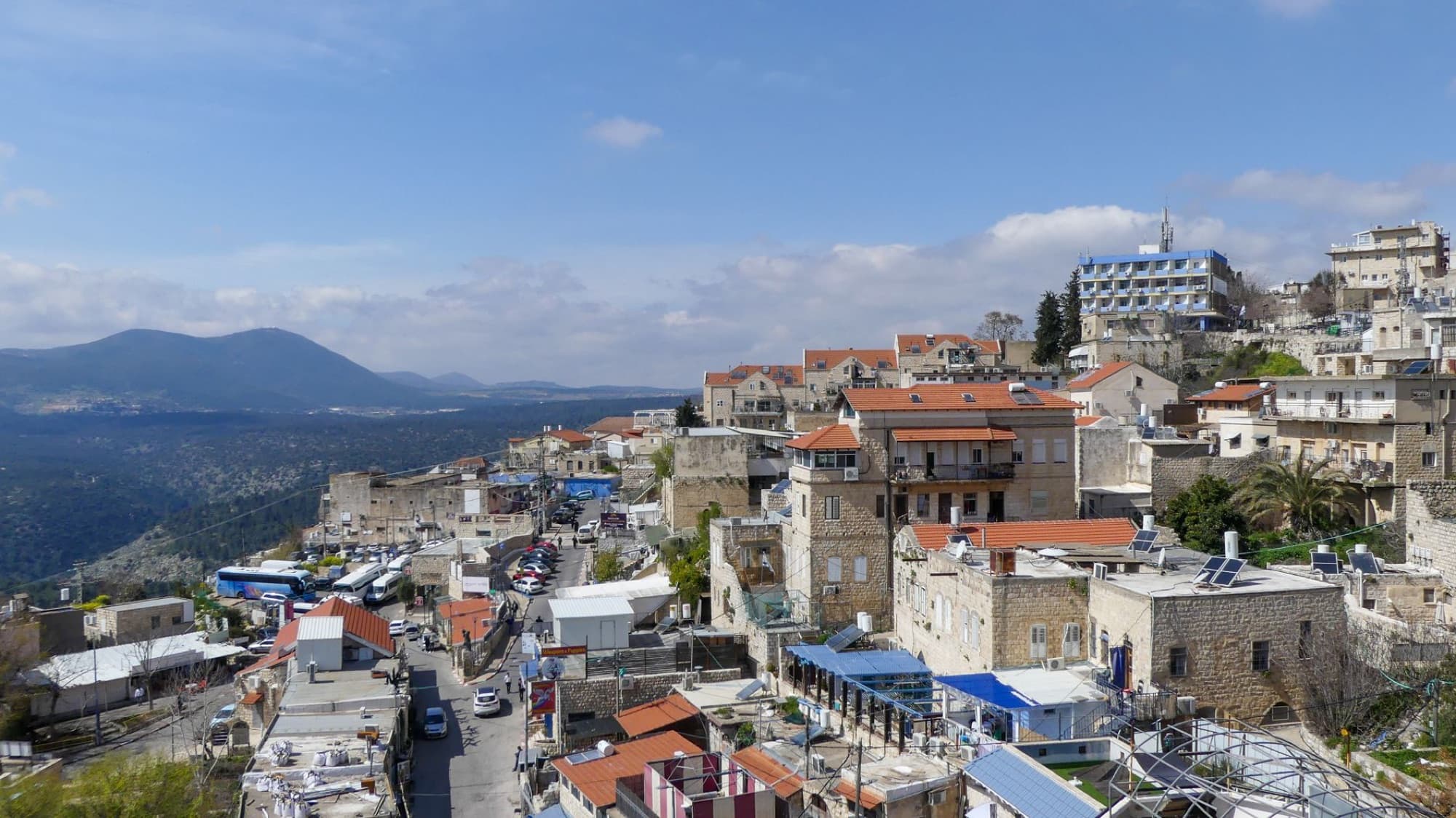 Stunning view of Safed, Israel, showcasing historic stone buildings under a clear blue sky.