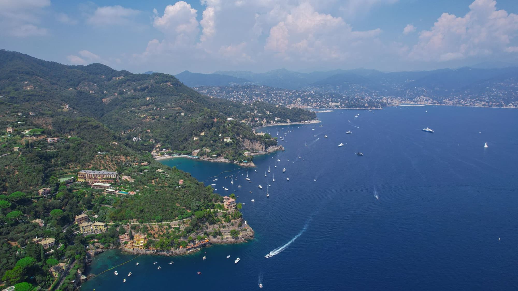 Breathtaking aerial panorama of Portofino's lush coastline and deep blue water, Liguria, Italy.