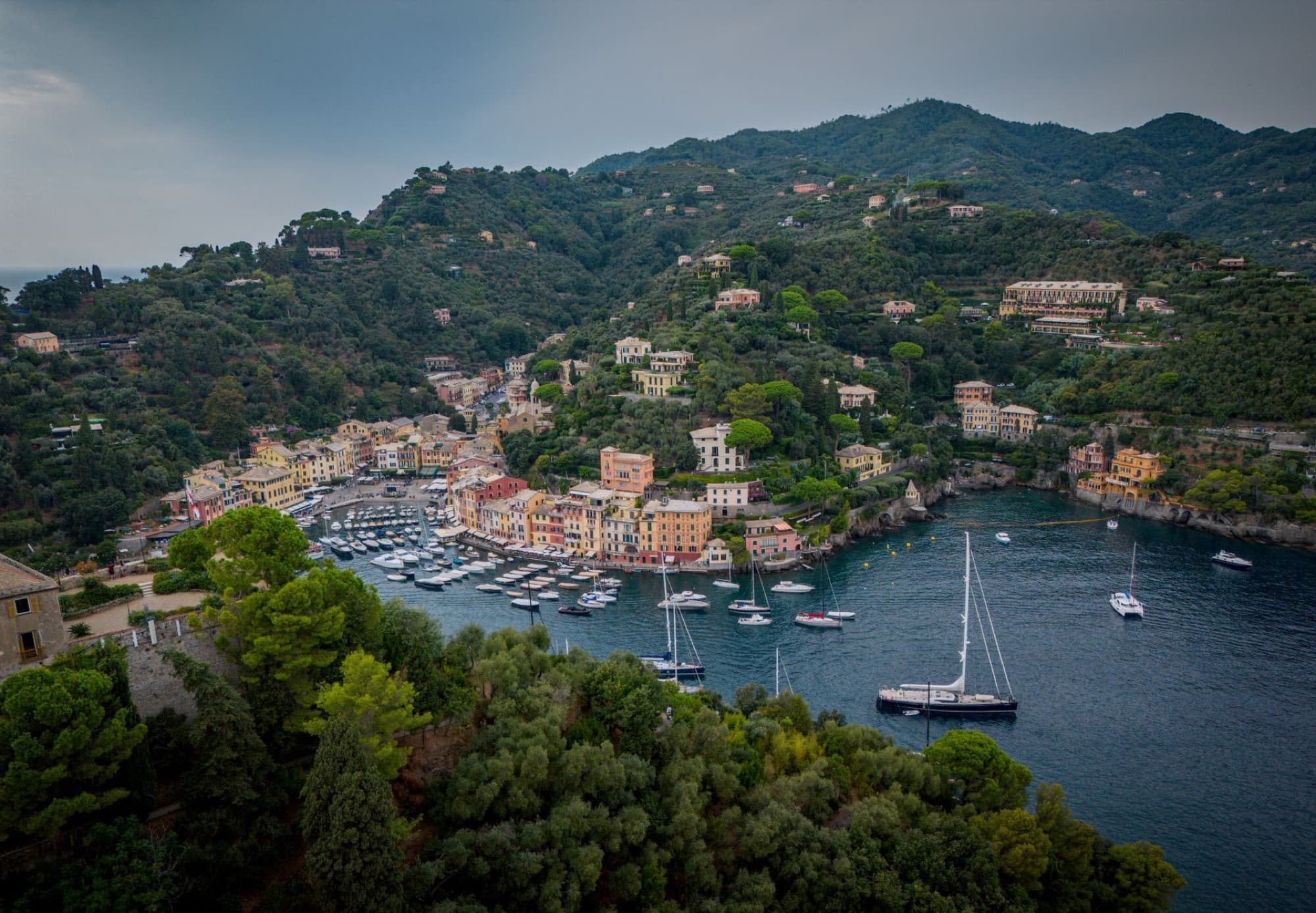 Breathtaking aerial view of Portofino, Italy showcasing colorful buildings and yachts in the harbor.