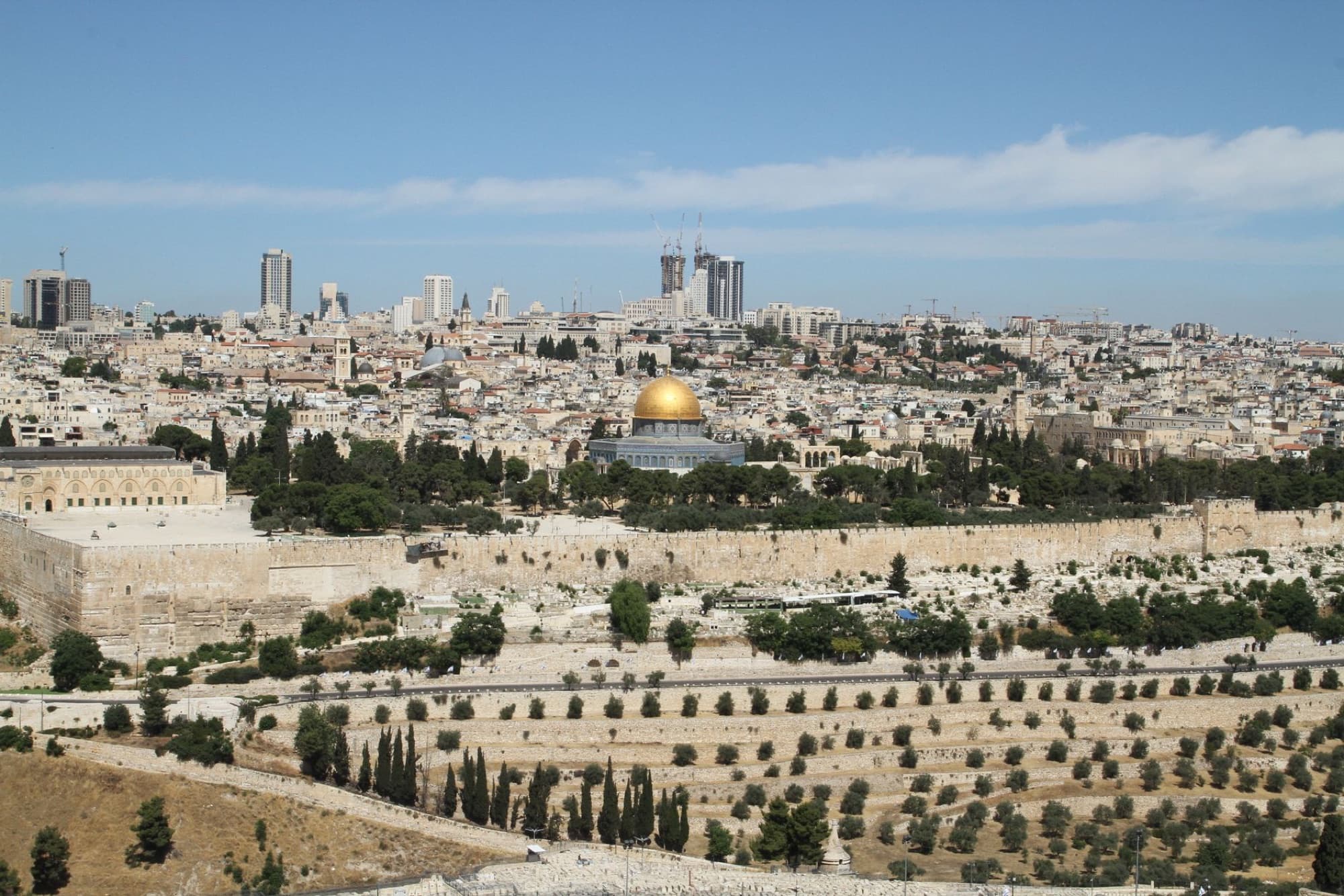 Captivating aerial view of Jerusalem featuring the iconic Dome of the Rock and surrounding old city landscape.