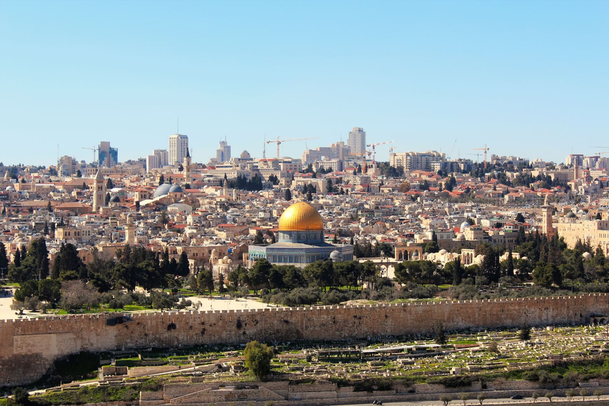 Stunning aerial shot of the Dome of the Rock and Jerusalem skyline, capturing the historic and urban landscape.