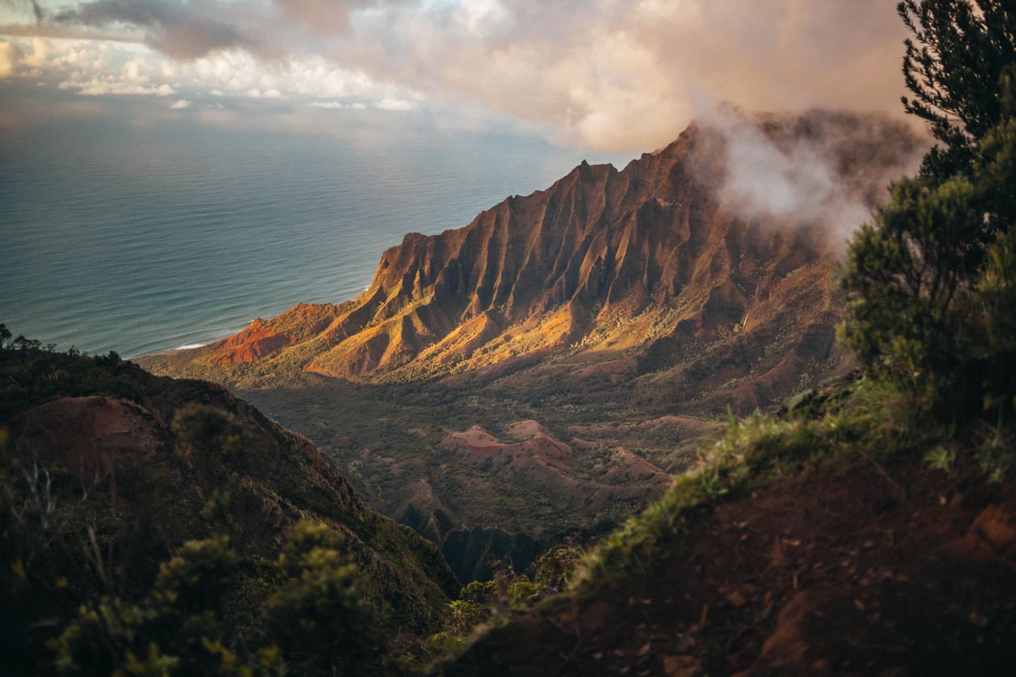 A stunning view of the Kalalau Valley with mountains and ocean in Kauai, Hawaii.