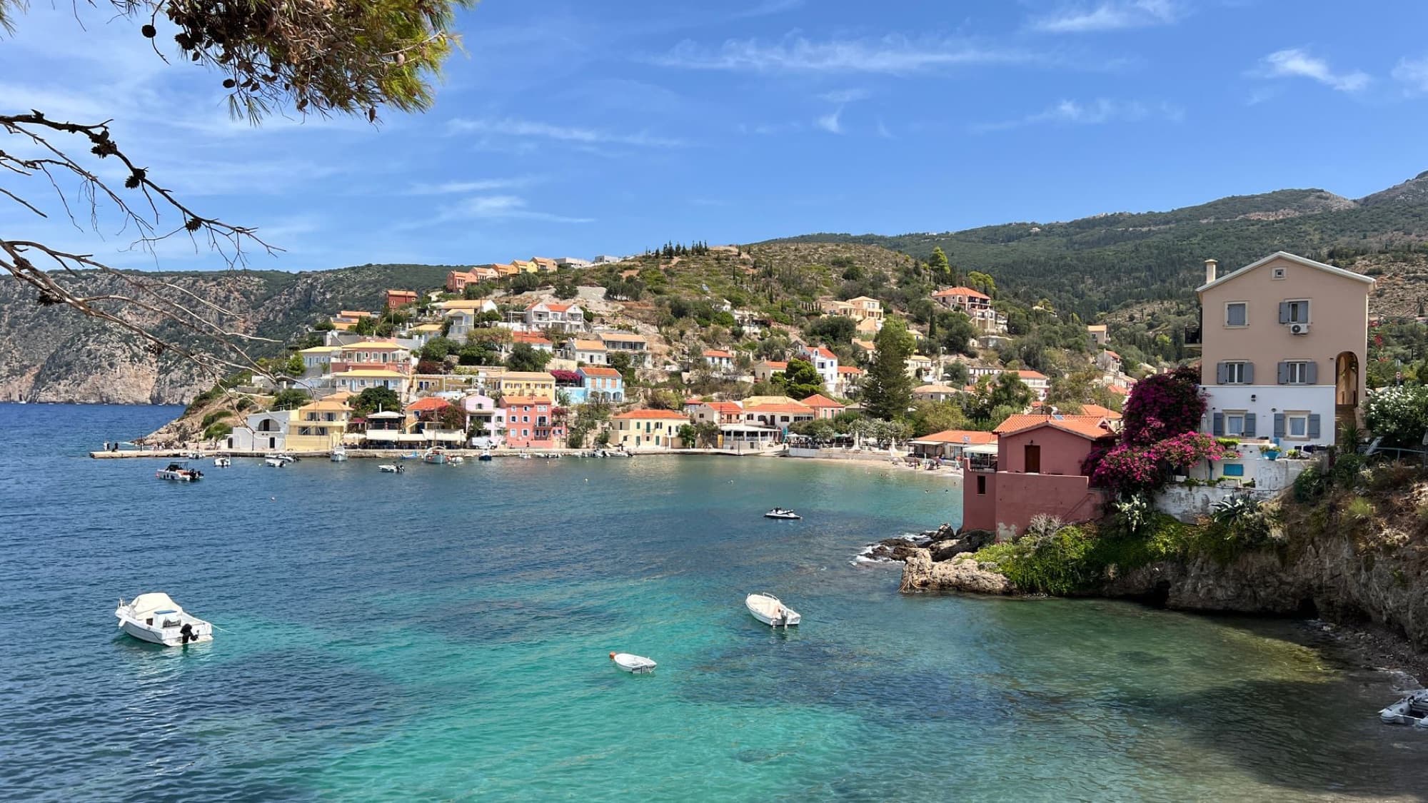 Picturesque coastal village of Assos in Kefalonia with colorful houses and clear sea.