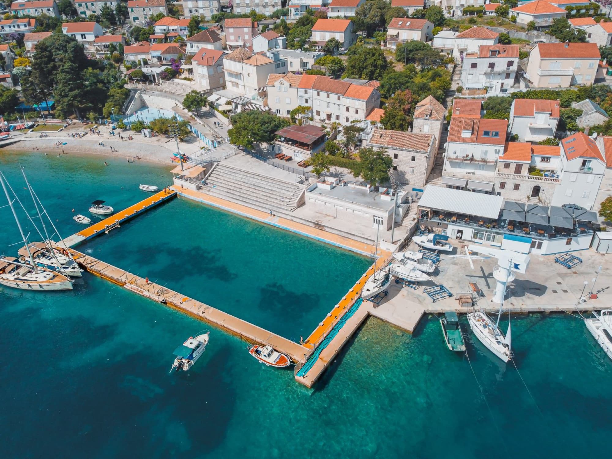 Stunning aerial shot of a coastal town's swimming area in Korcula, Croatia.