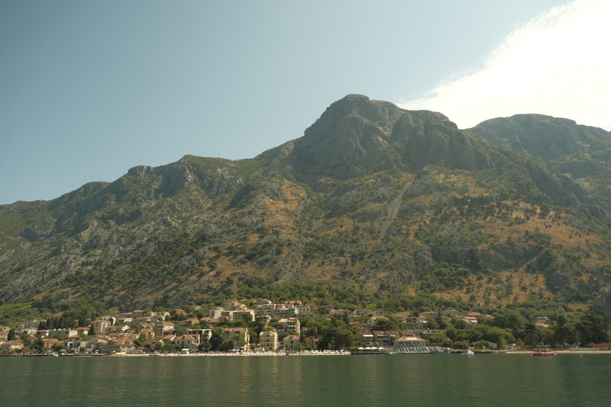 Picturesque landscape of Kotor Bay with rugged mountains and coastal village views.