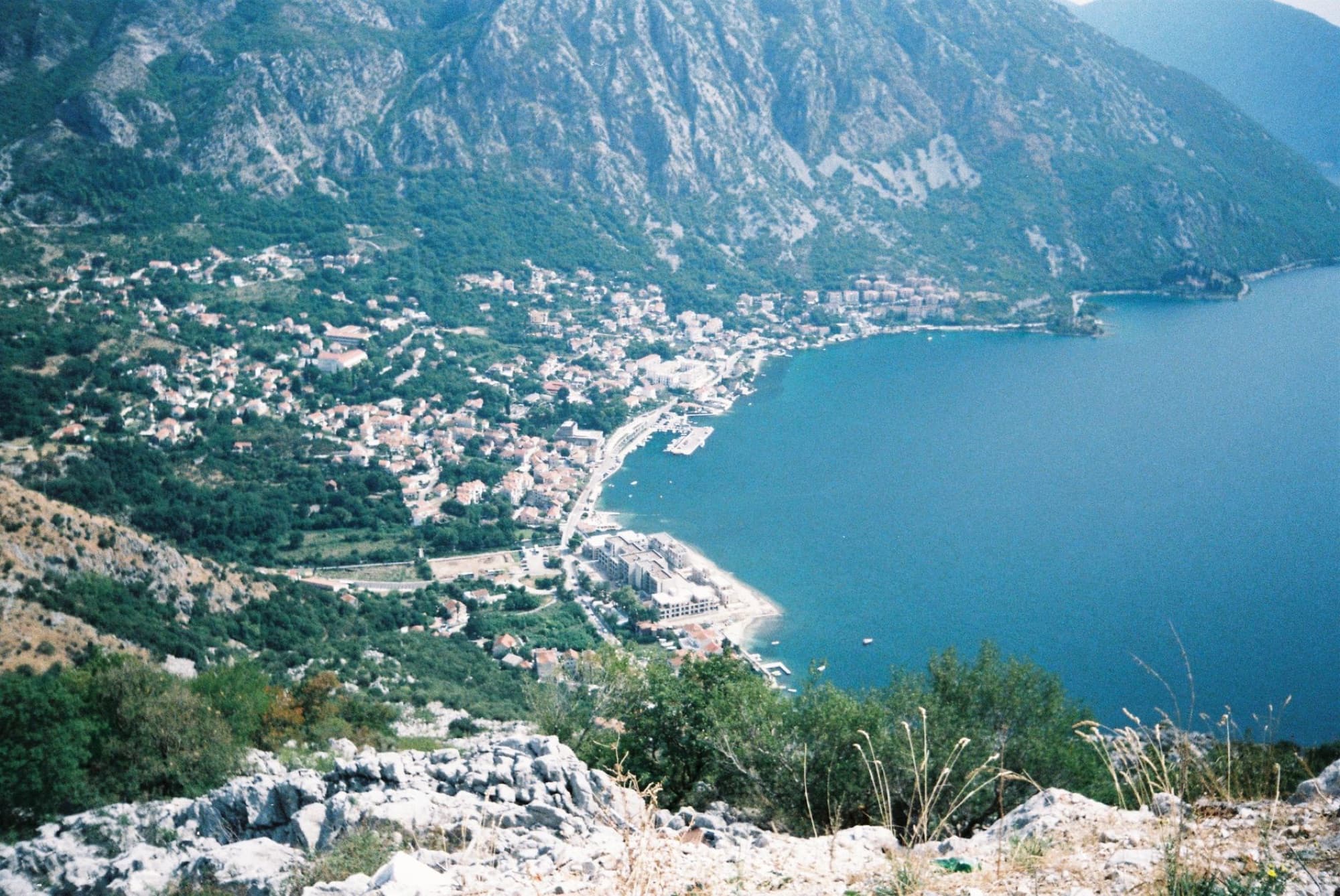 Scenic aerial shot of Kotor Bay's stunning coastline and surrounding mountainous landscape in Montenegro.