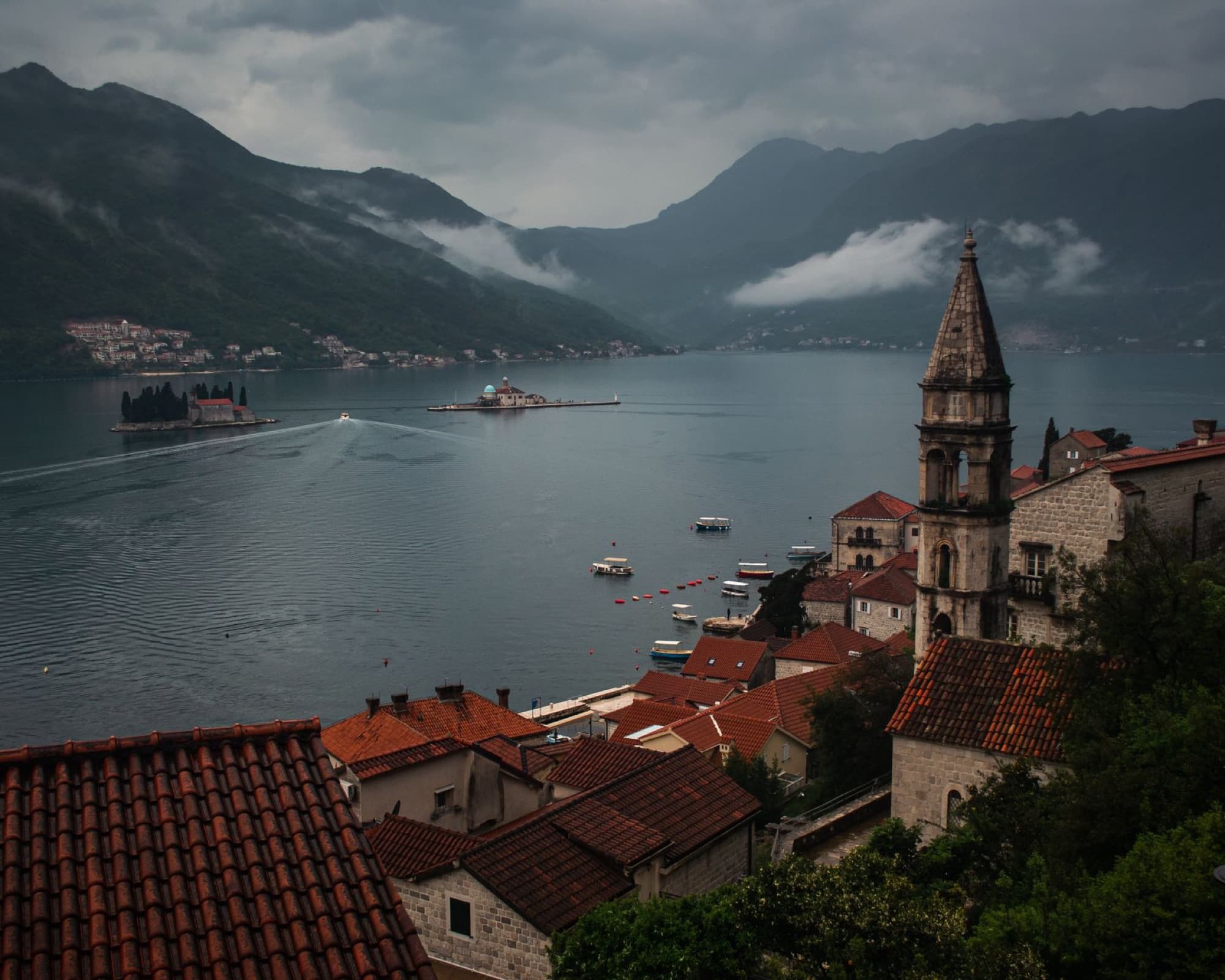 Scenic view of Kotor Bay, Montenegro with mountains, historic town, and serene waters.