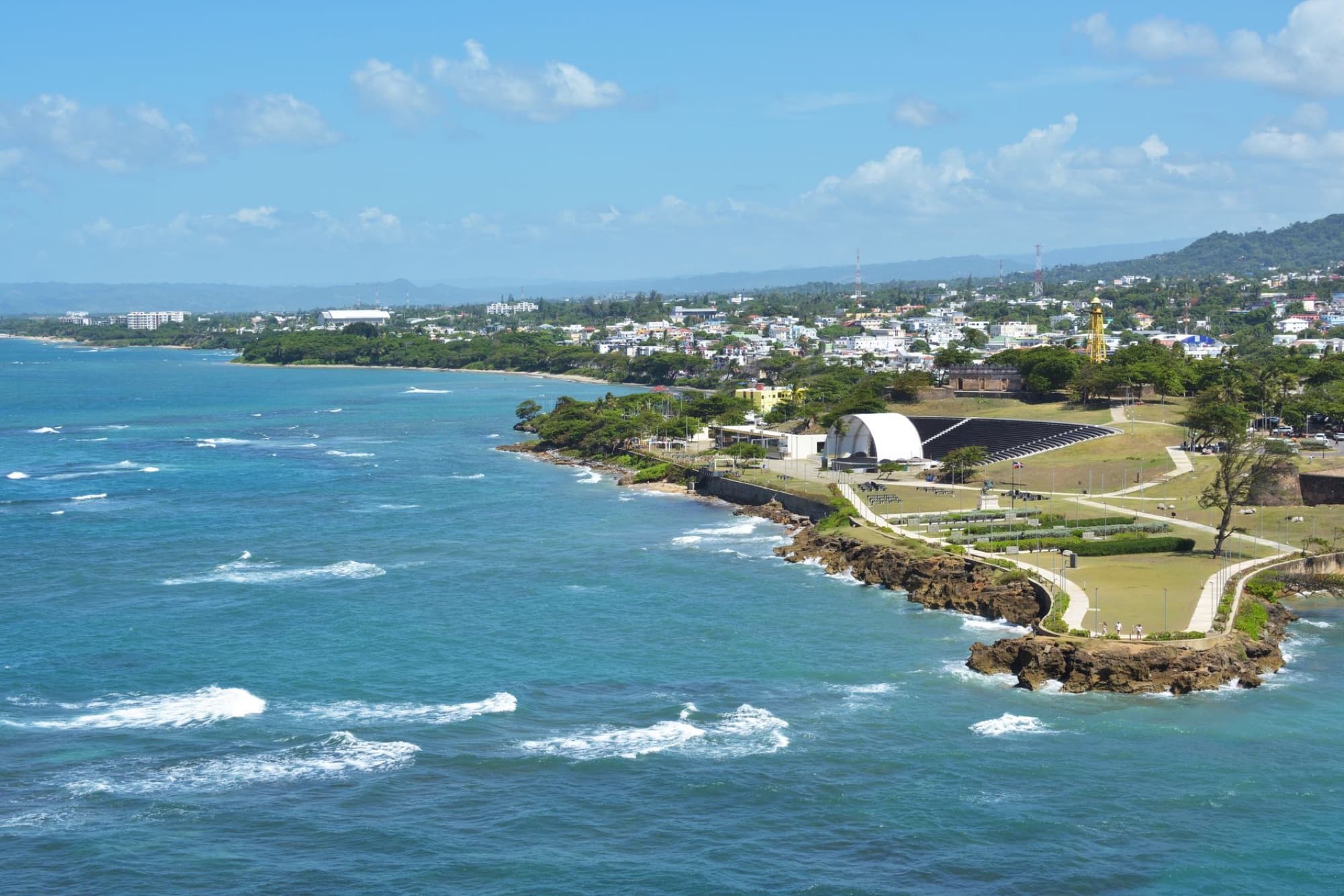 Scenic aerial view of Puerto Plata's coastline in the Dominican Republic under a blue sky.