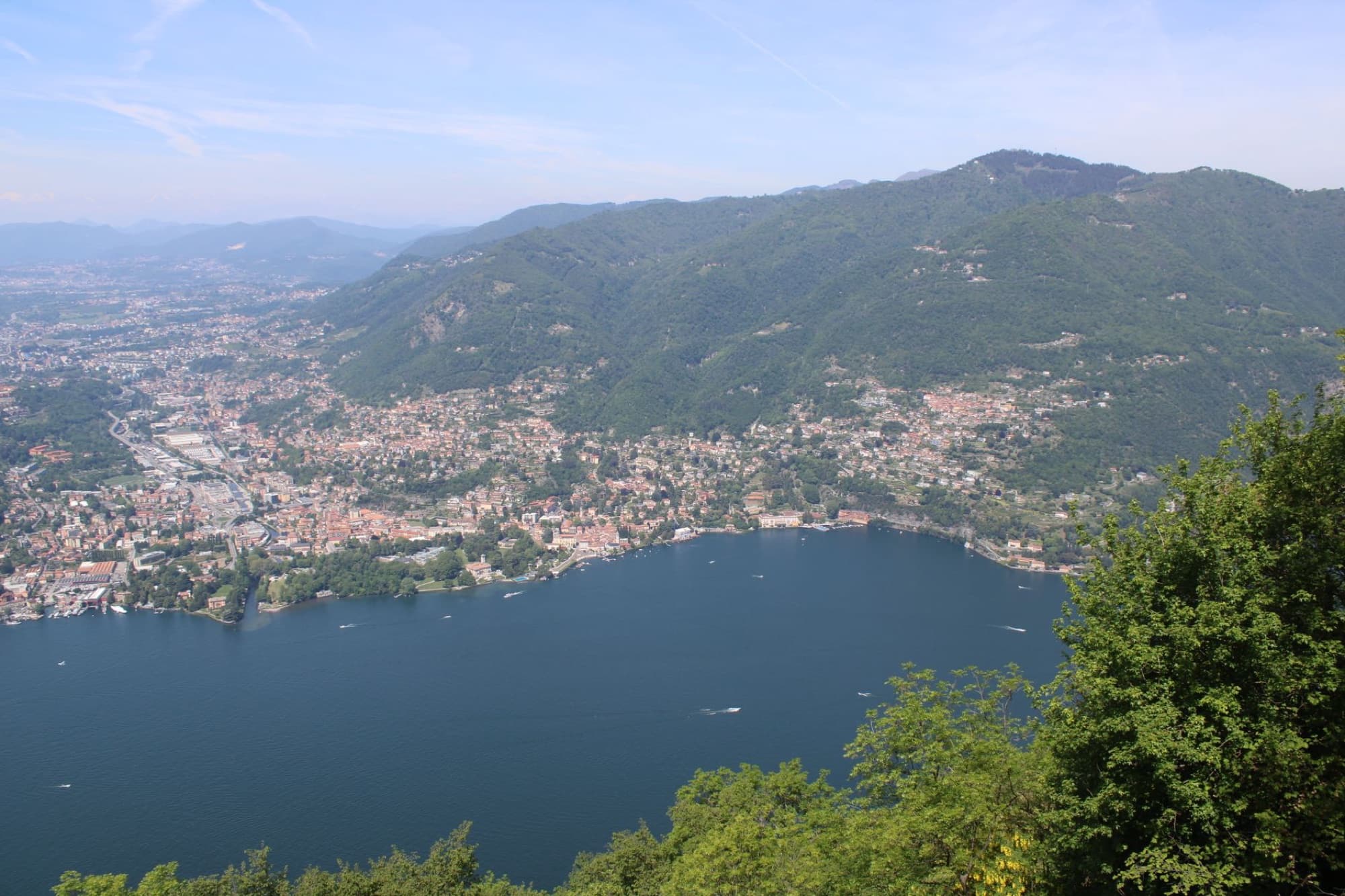 Scenic aerial view of Lake Como and surrounding mountains in Lombardia, Italy on a sunny day.