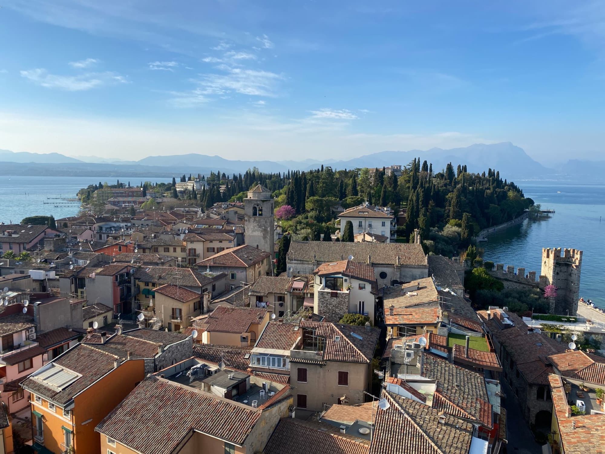 Aerial view of the historic town Sirmione on Lake Garda with scenic landscapes and medieval architecture.