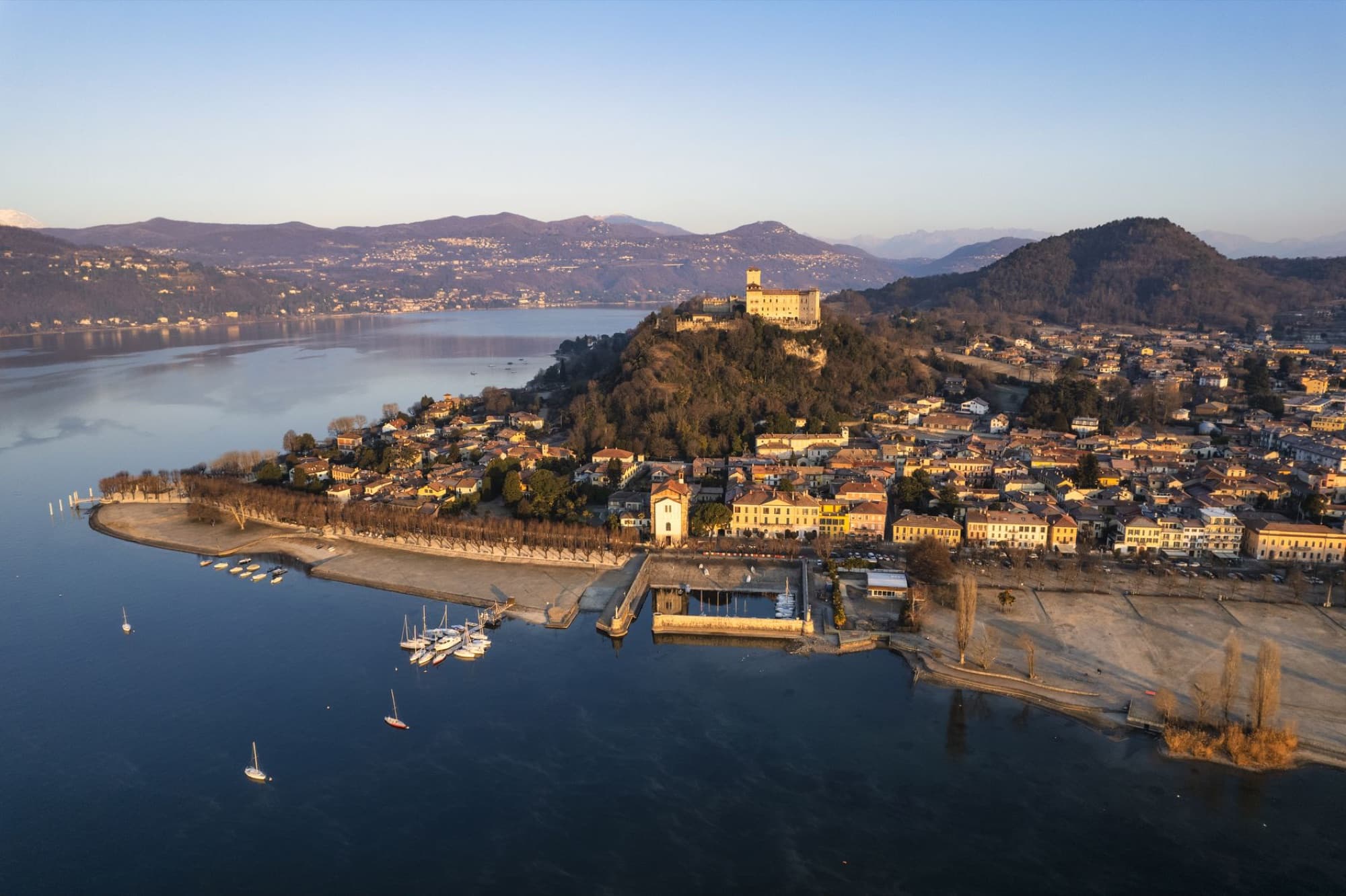 Aerial view of Angera castle and village on Lake Maggiore at sunset.