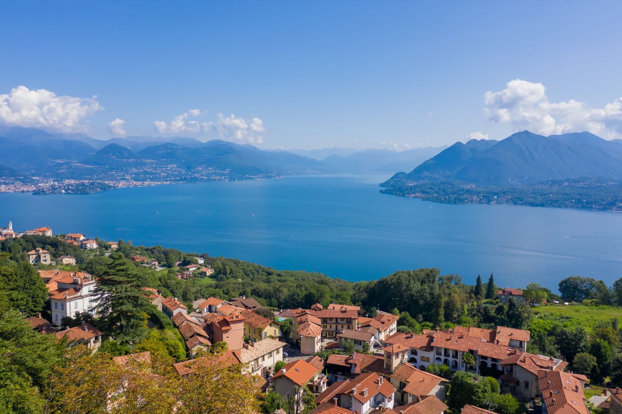 Breathtaking aerial view of Lake Maggiore with mountains and town in northern Italy.