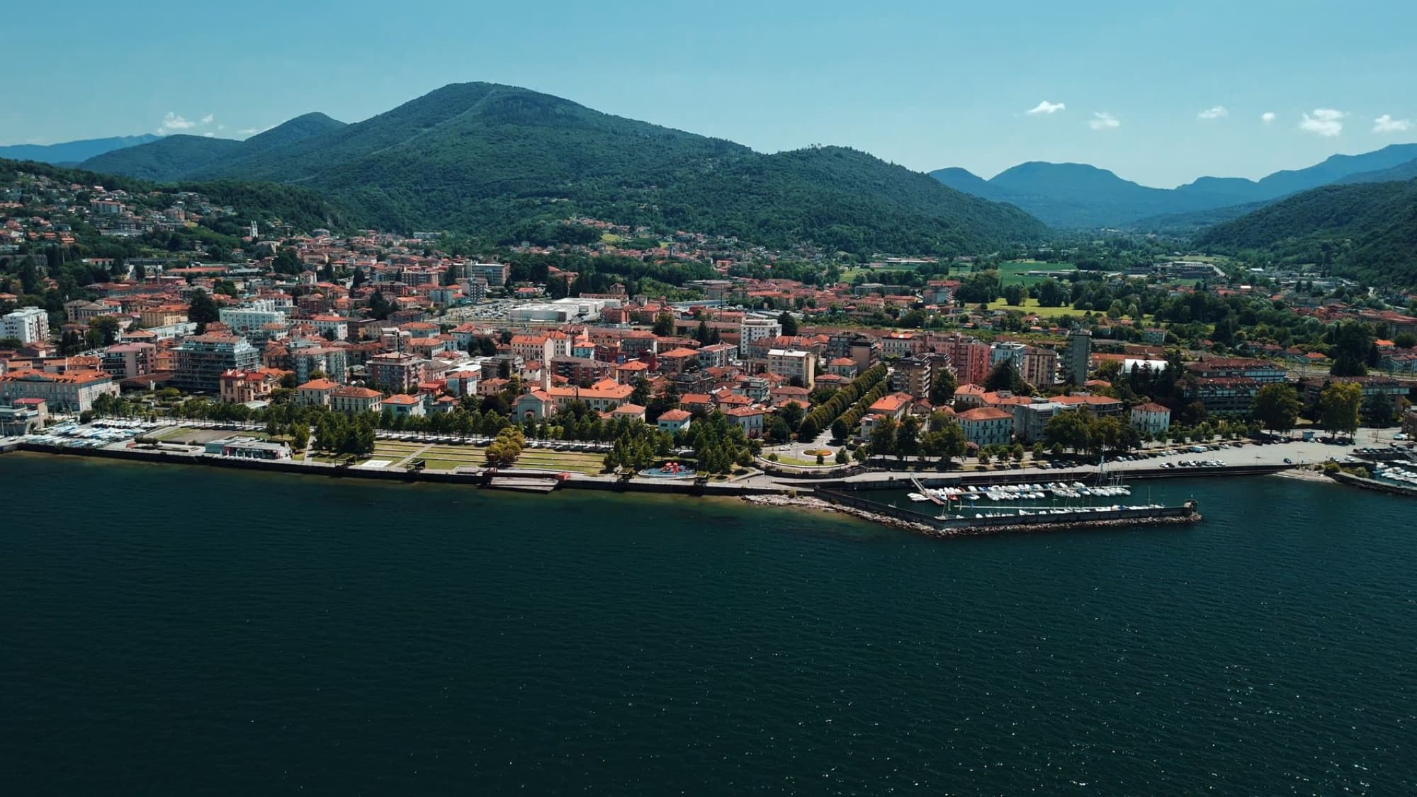 Beautiful aerial view of Verbania and Lake Maggiore with lush mountains in Italy.