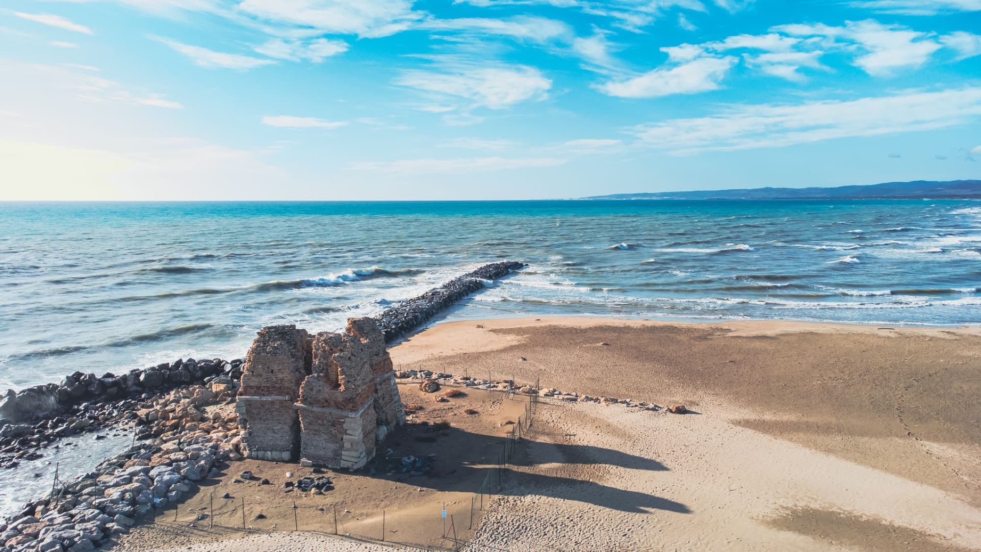 Drone shot of ancient ruins at Ladispoli beach, Lazio, Italy, with scenic seascape.