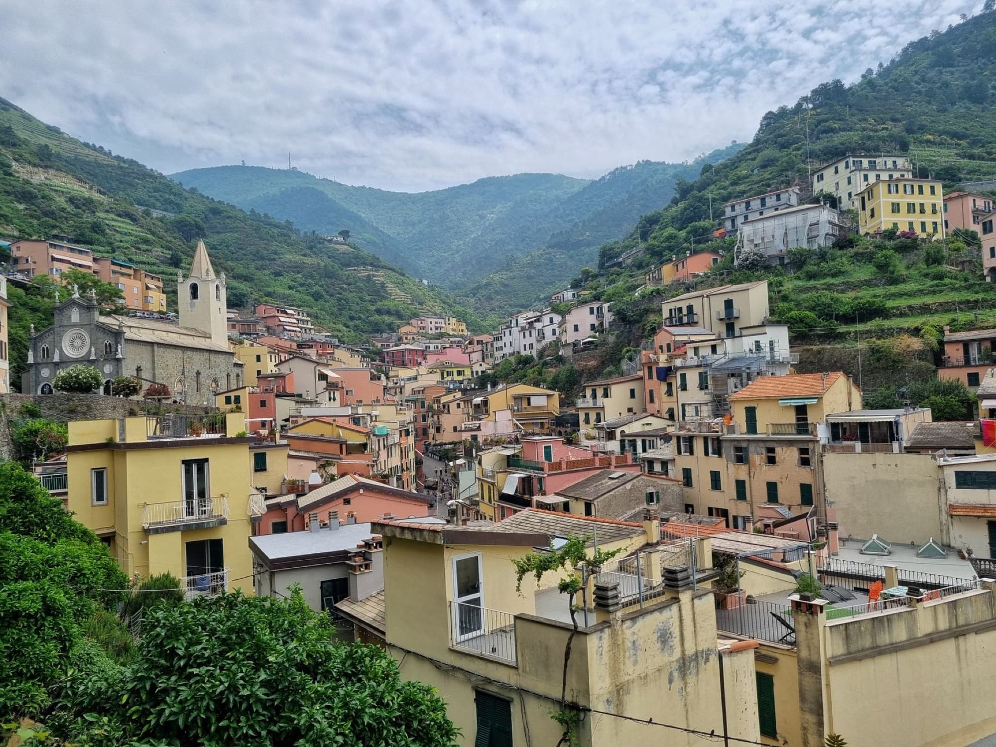 Picturesque aerial view of colorful Vernazza village nestled in the hills of Liguria, Italy.