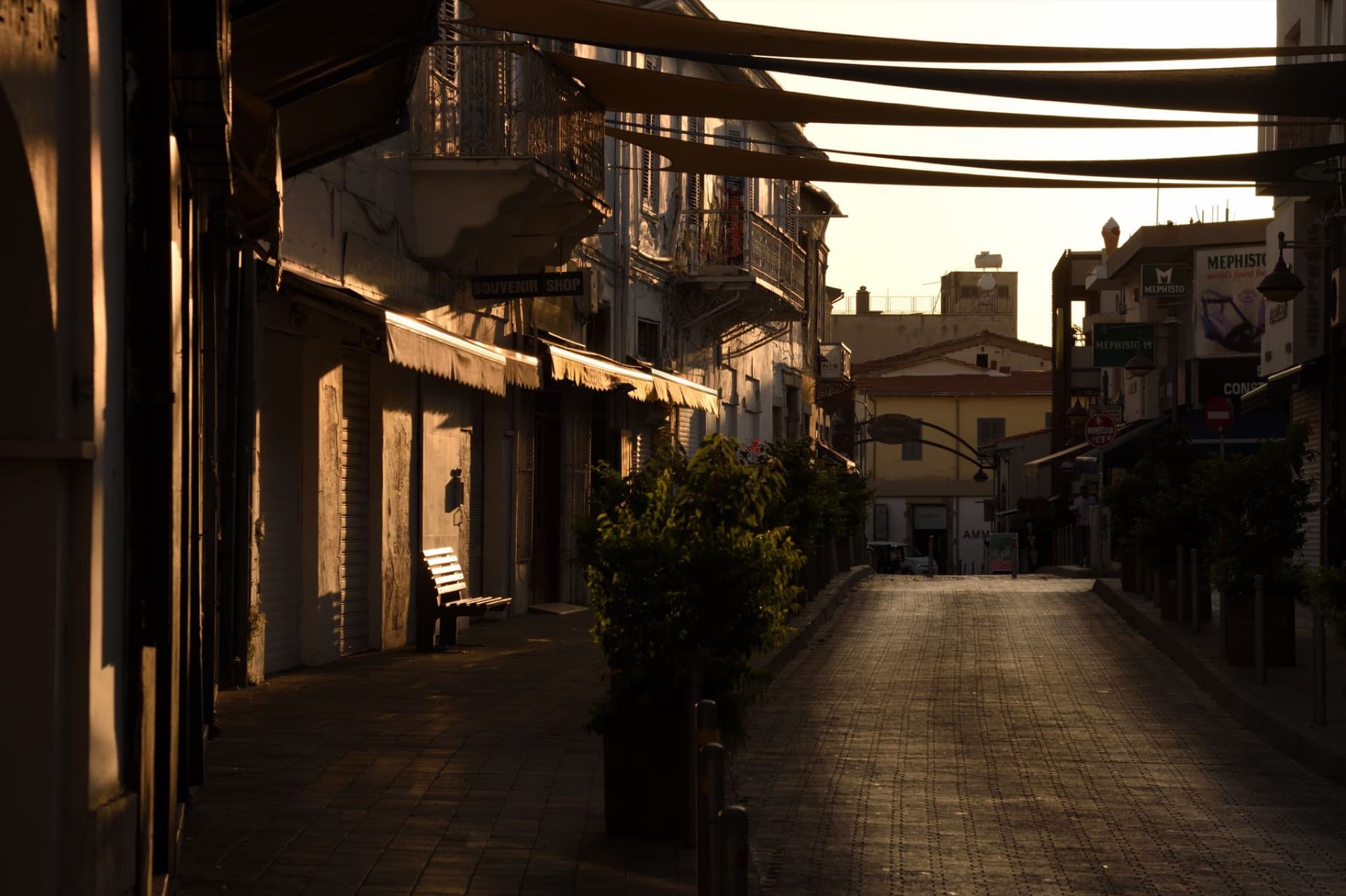 Narrow alleyway in Limassol, Cyprus at sunset offers tranquil charm and captivating shadows.