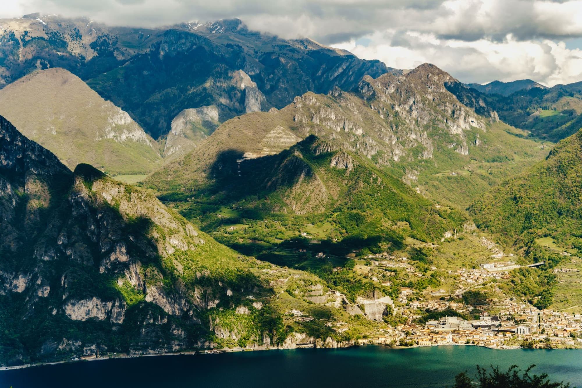 Breathtaking aerial view of Iseo Lake surrounded by majestic mountains in Lombardy, Italy.