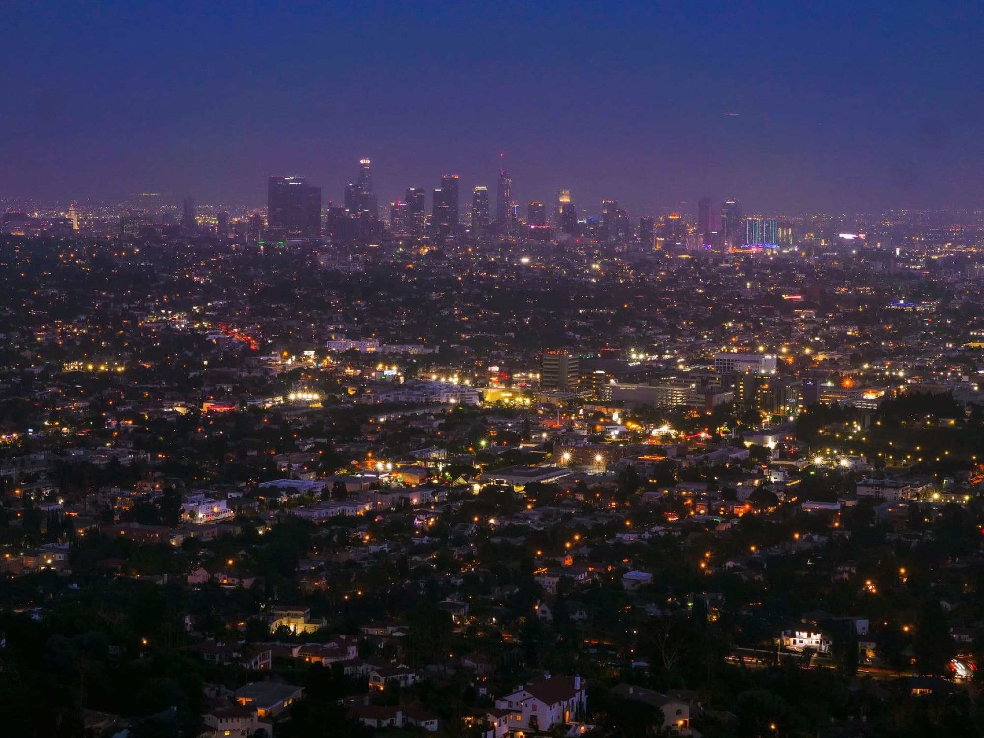 Aerial view of Los Angeles city lights and skyline at night, capturing urban beauty.