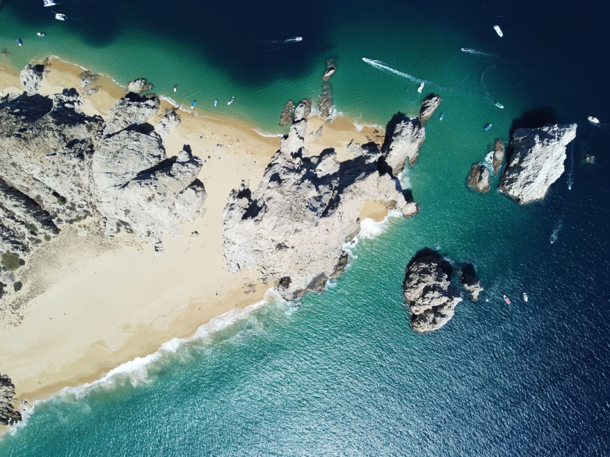 Stunning aerial shot of the rocky coast and turquoise waters in Cabo San Lucas, Mexico.
