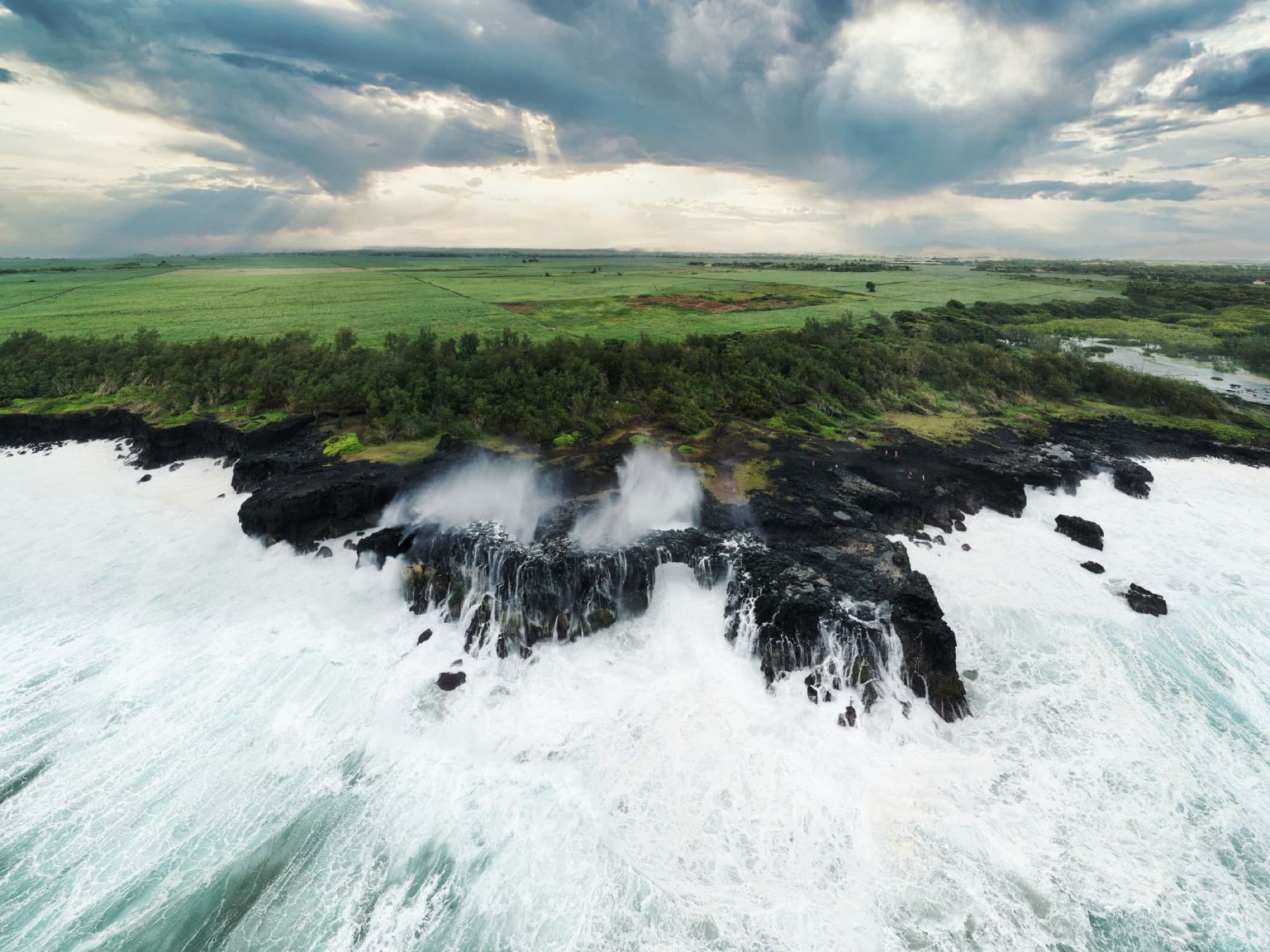 Stunning aerial view of waves crashing along the cliff coast in Grand Port, Mauritius.