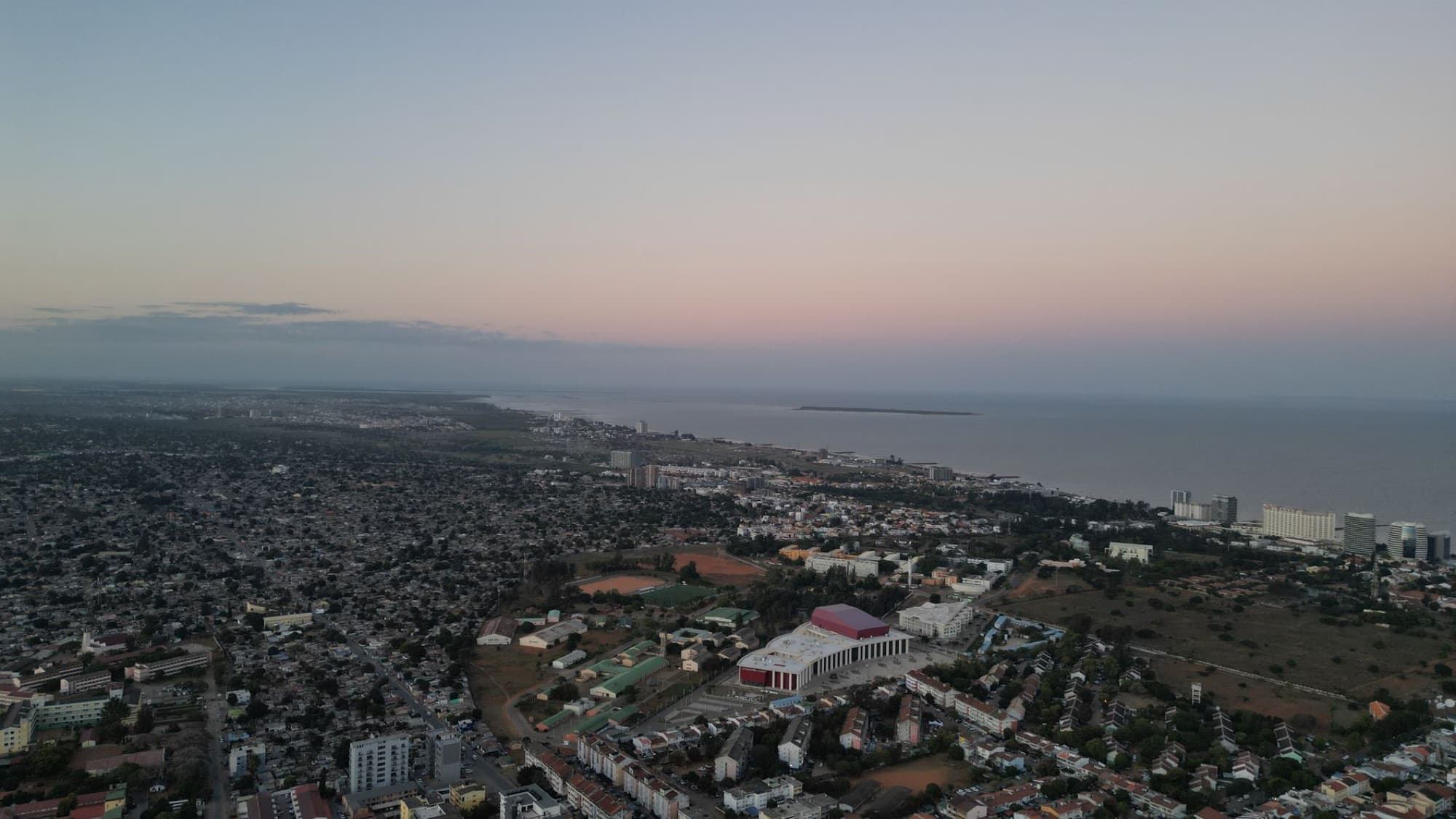 Stunning aerial view of Maputo, Mozambique during twilight, showcasing the cityscape and coastline.