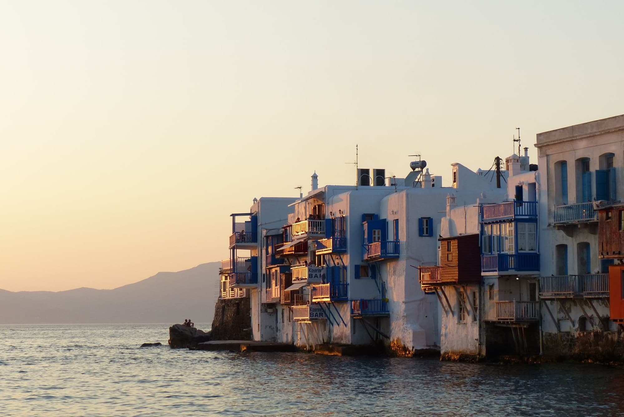 Charming sunset view of the iconic Little Venice architecture on Mykonos island, Greece, by the sea.
