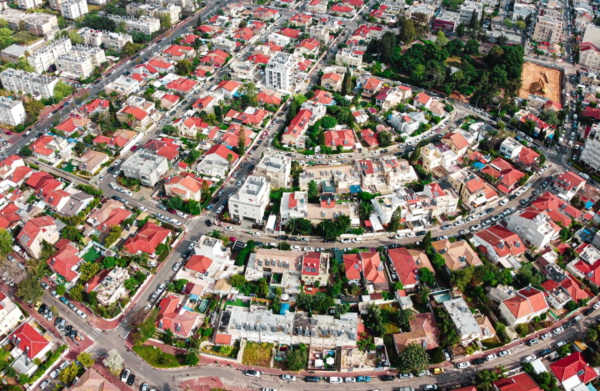 Colorful aerial view of a residential area in Holon, Israel showcasing rooftops and urban planning.