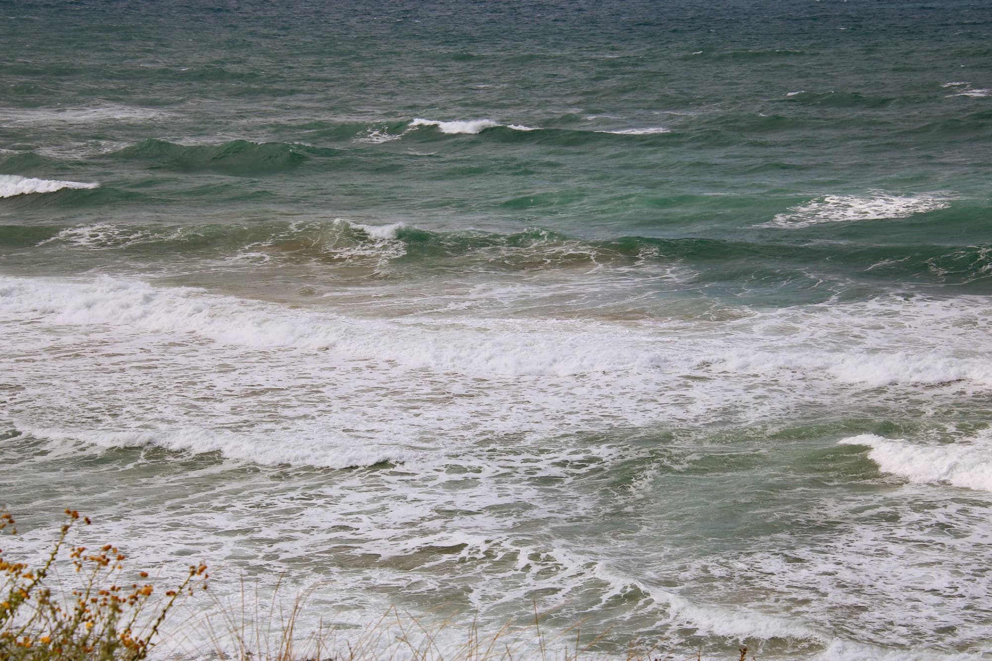 Dynamic waves crash on the scenic Netanya coastline in Israel, captured on a sunny day.