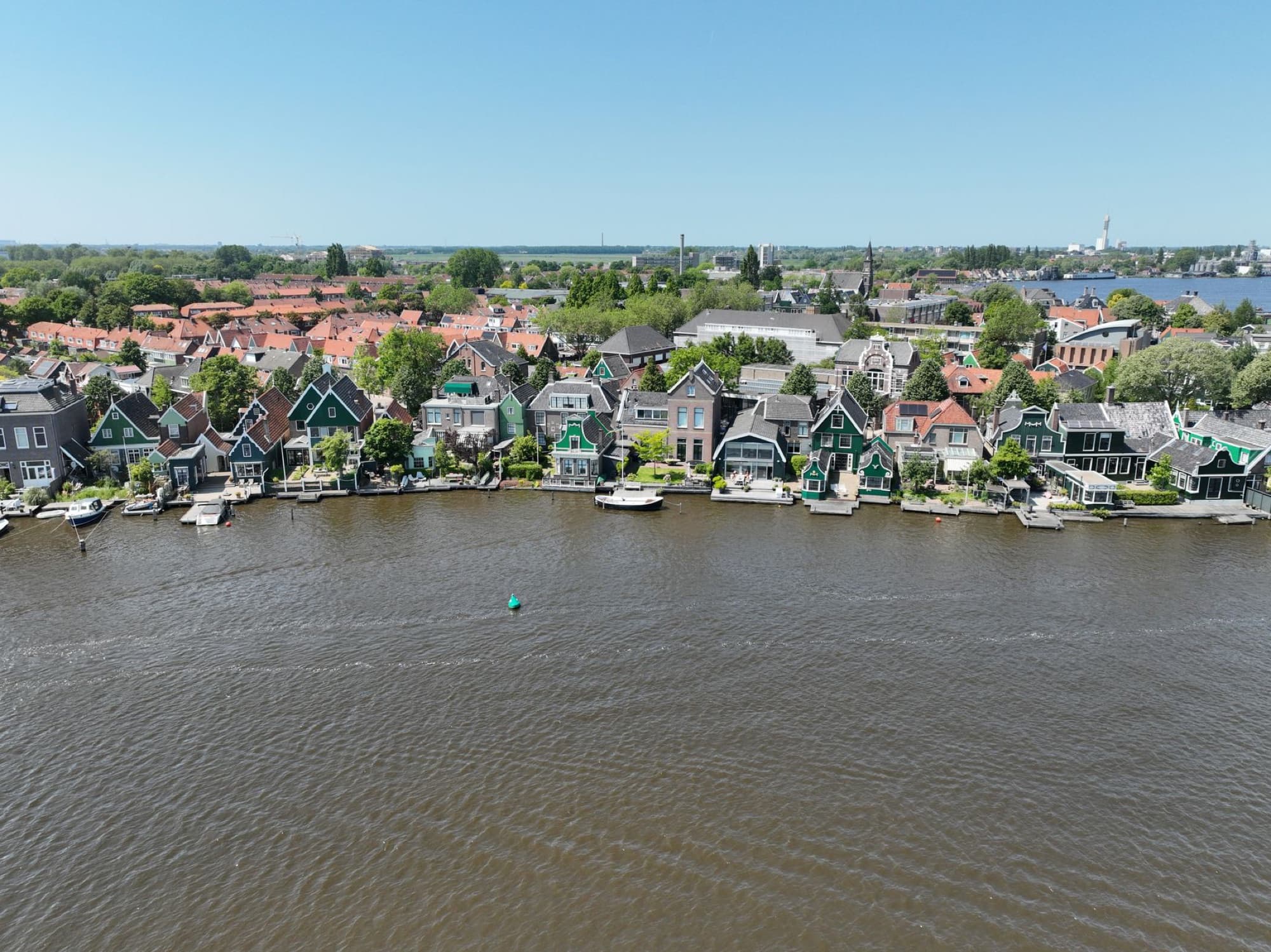 Scenic aerial view of traditional houses along the river in Zaandam, Netherlands.