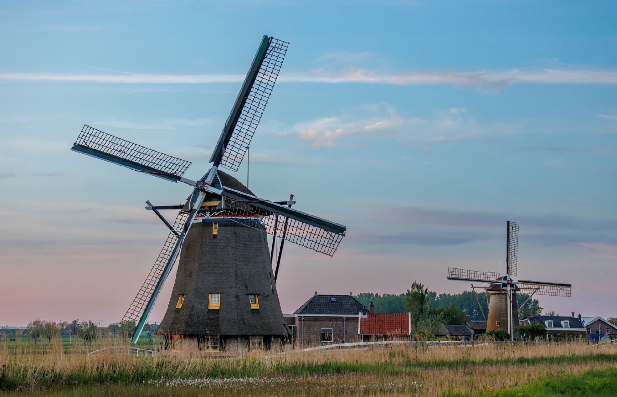 Beautiful windmills in Maasland, Netherlands at sunset, capturing scenic rural charm.