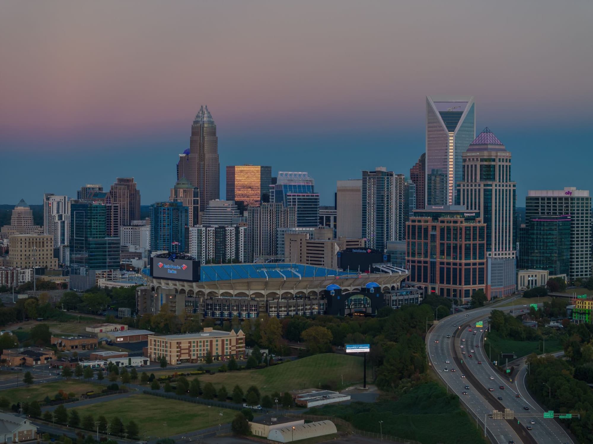 Aerial view of Charlotte skyline and Bank of America Stadium at dusk, North Carolina, USA.