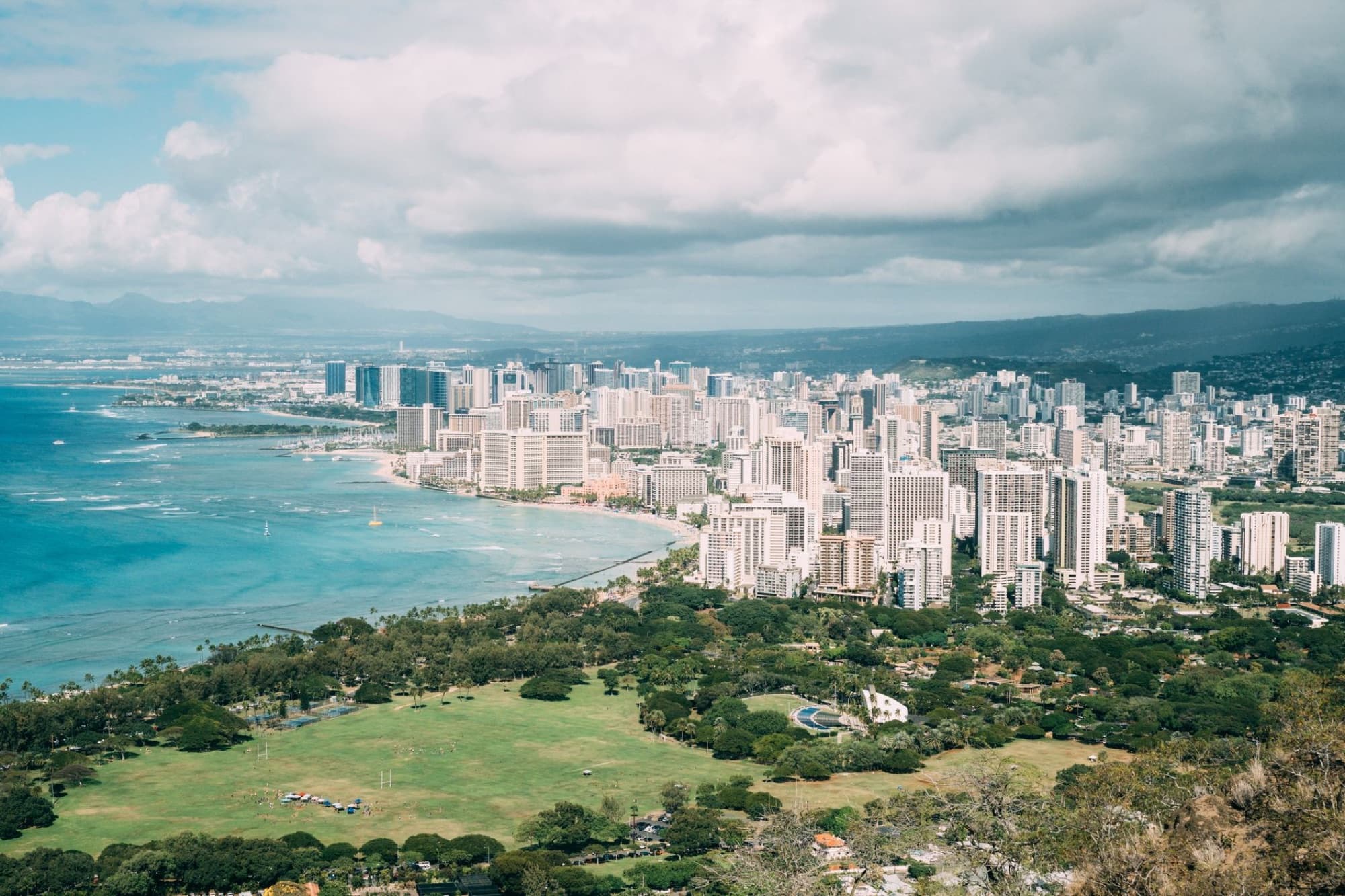 Stunning aerial view of Honolulu's skyline along the beautiful oceanfront, showcasing the city's urban landscape.