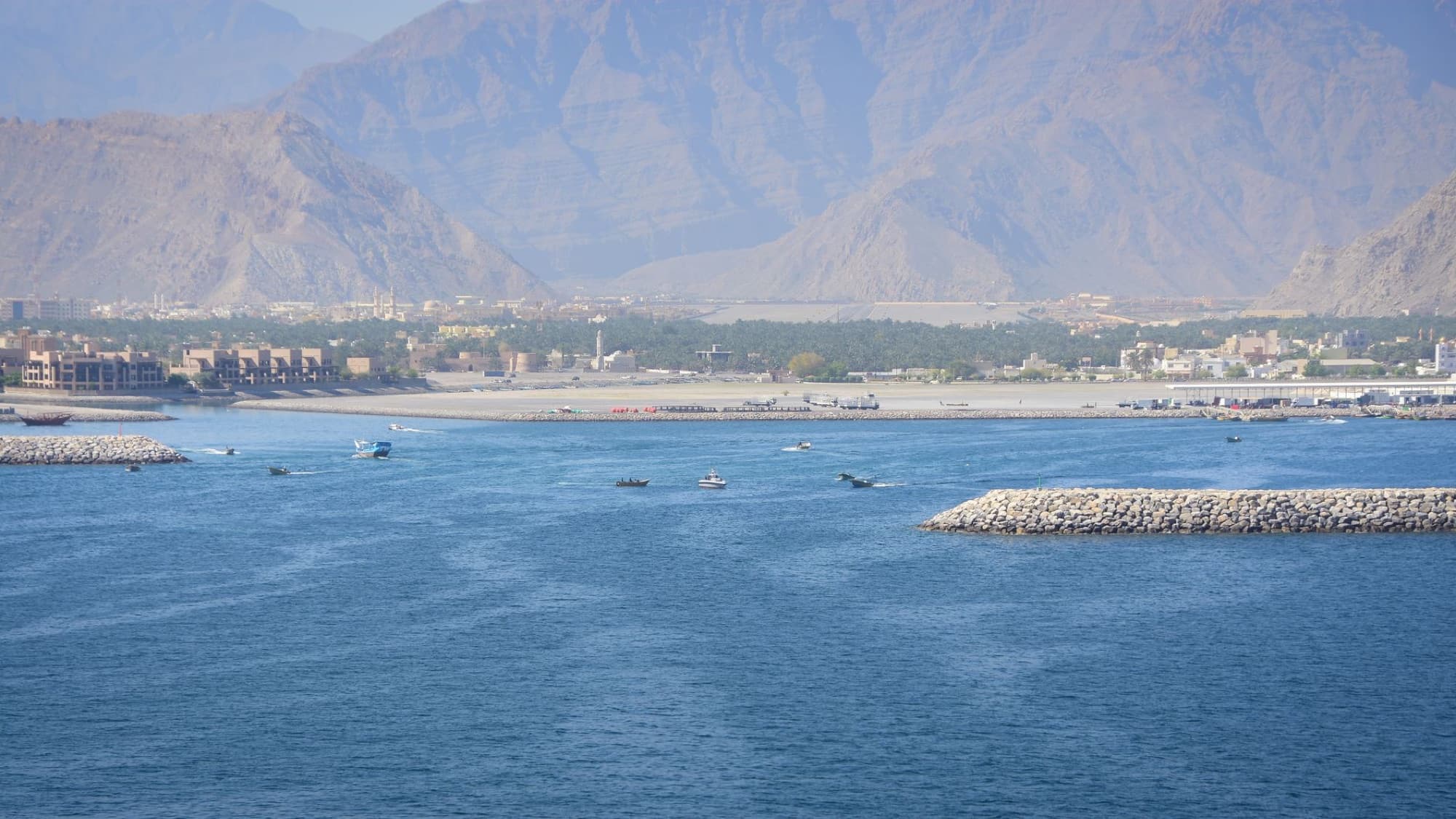 Aerial view of al-Chasab Harbor with boats and mountains in Musandam, Oman.