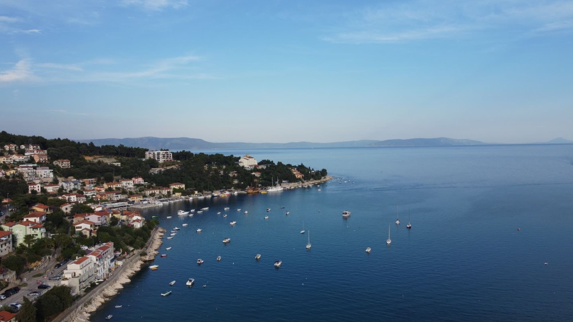 Scenic aerial view of Rabac's coast and Adriatic Sea, showcasing charming coastal town and serene waters.