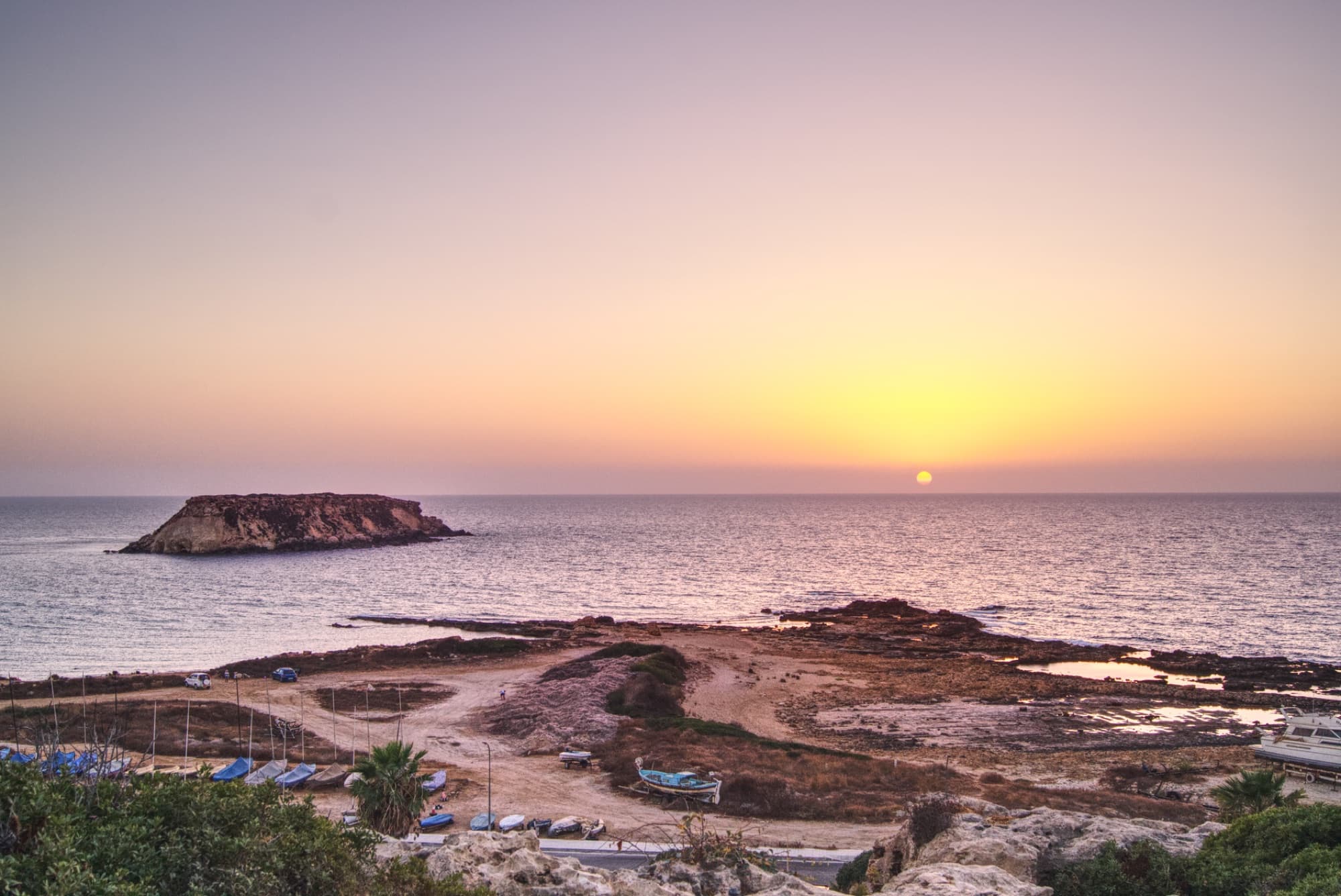 Tranquil sunset view over the sea and coastline in Paphos, Cyprus.