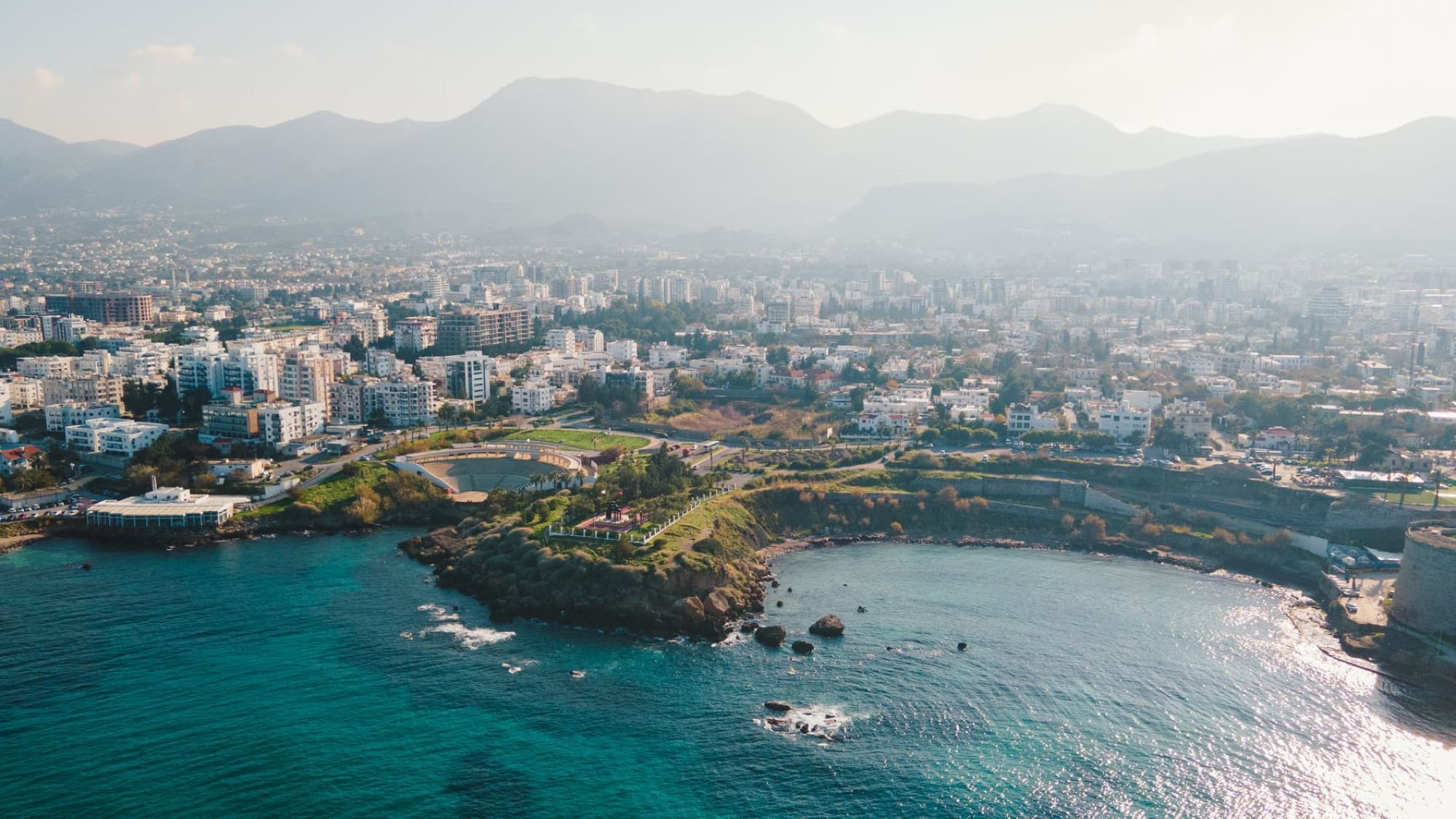 A stunning aerial shot capturing a coastal city's bustling urban landscape by day.
