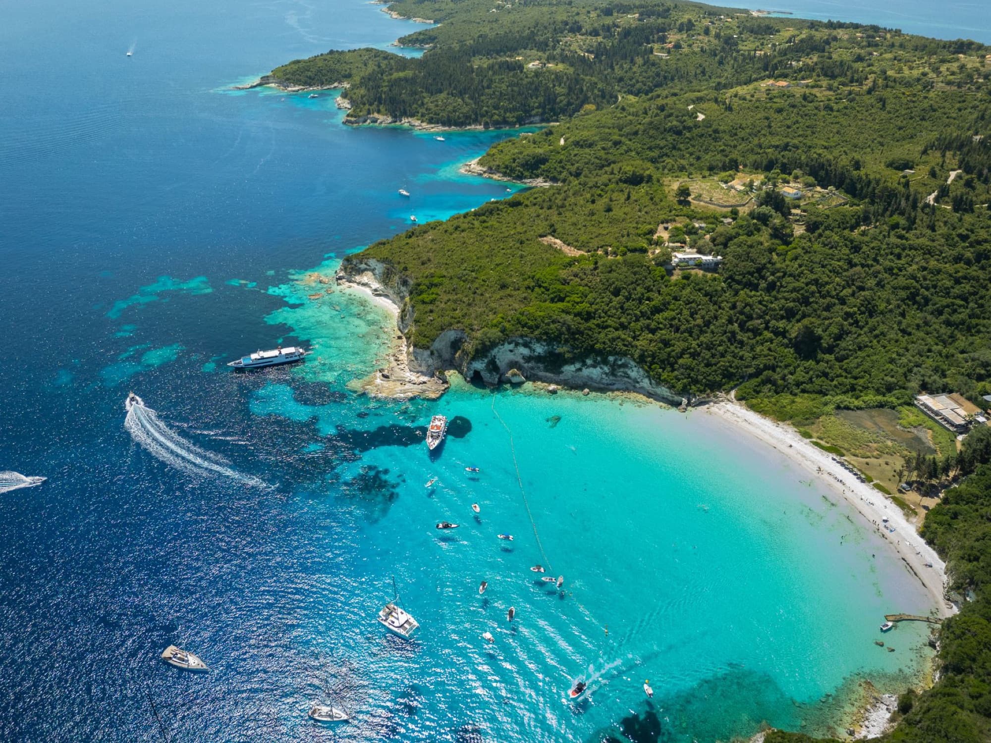 Stunning aerial view of turquoise waters and sandy beach on Paxos Island, Greece.