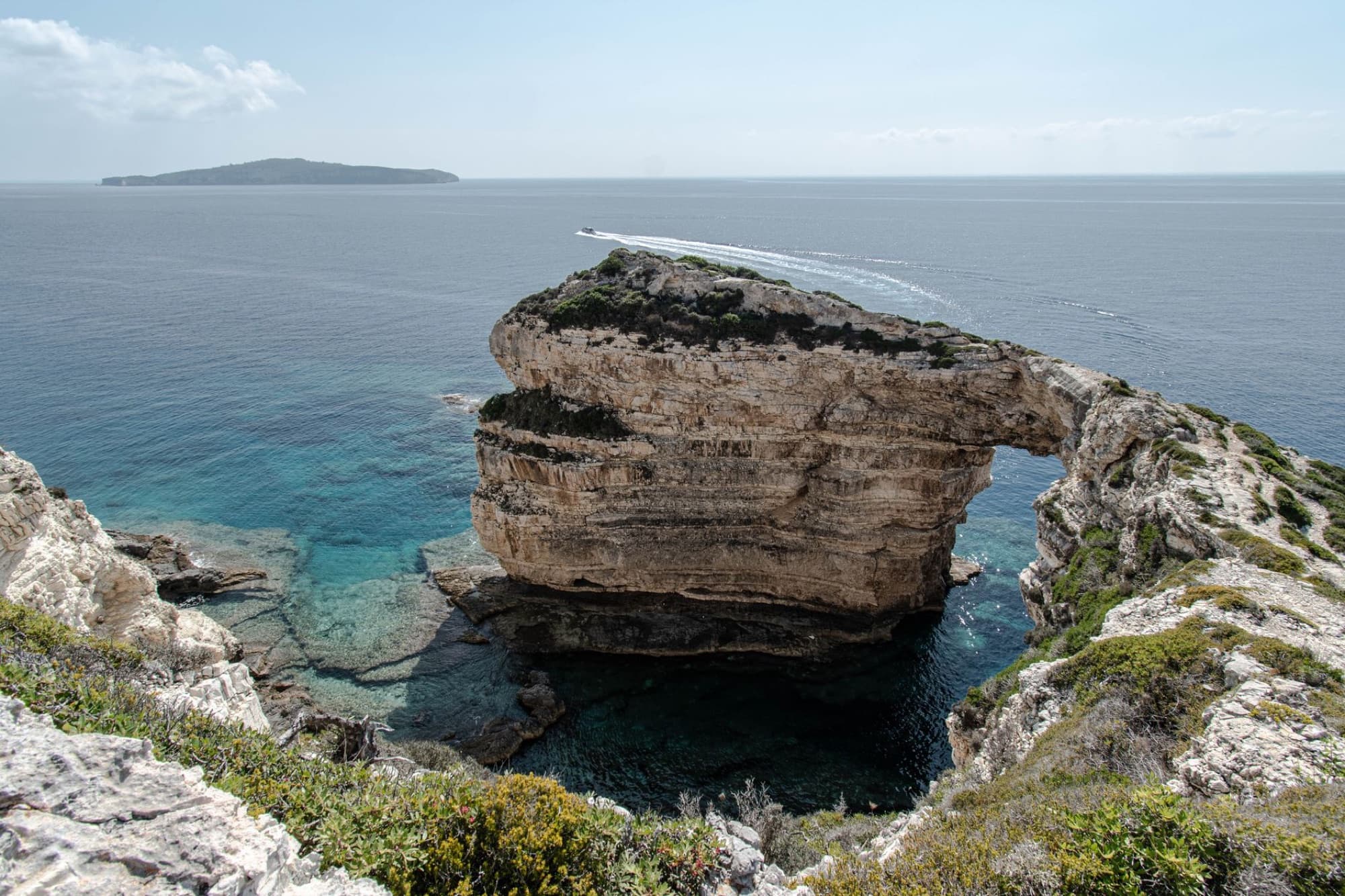Stunning rock arch formation along the coastline of Paxos, Greece.