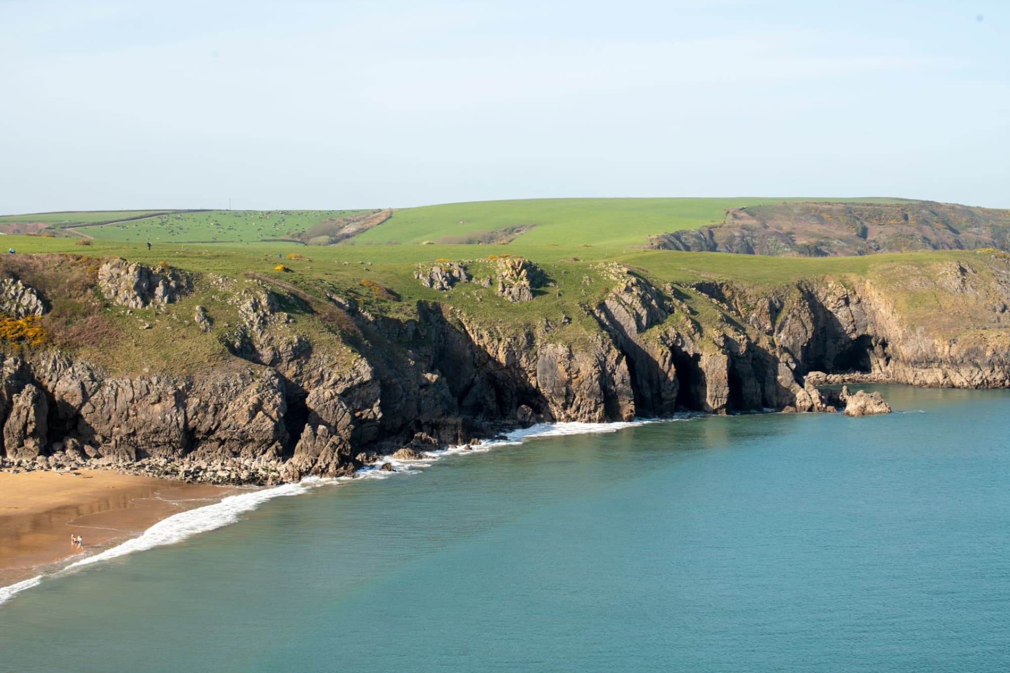 Breathtaking view of the rugged Welsh coastline with cliffs and blue sea in Pembrokeshire.