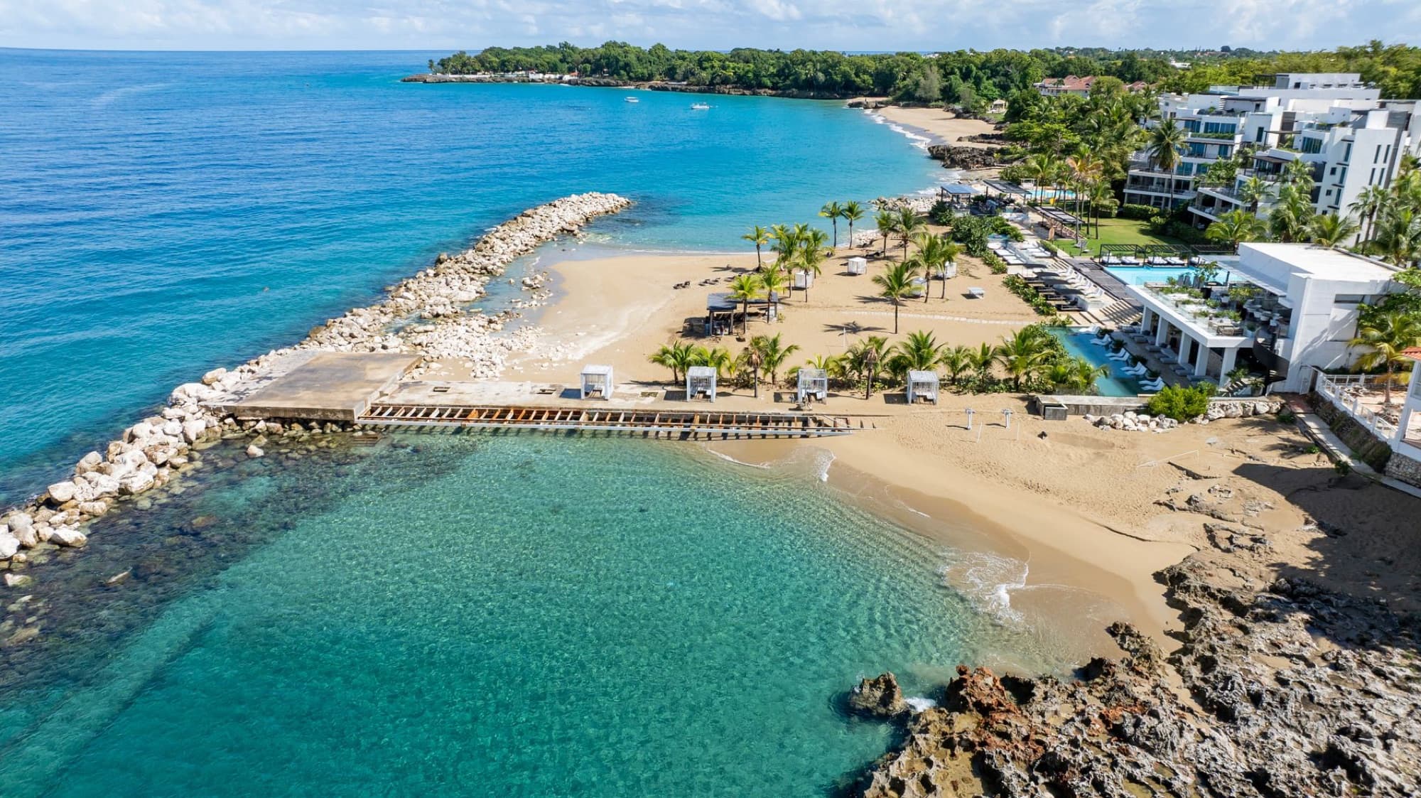 Stunning aerial photo of a beach resort in Sosúa, Dominican Republic featuring clear waters, sandy beaches, and lush greenery.
