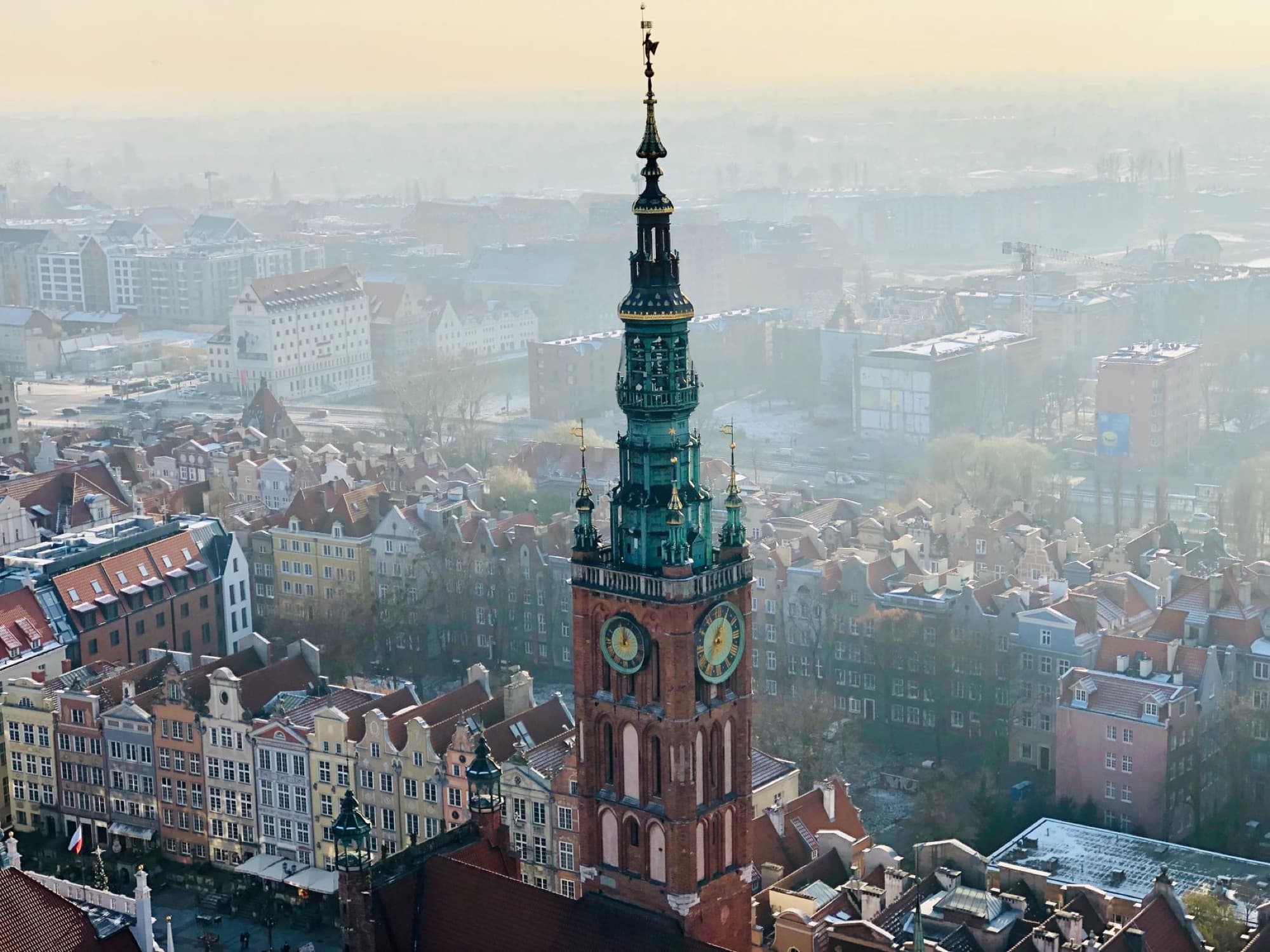 Captivating aerial view of historic Gdańsk Town Hall with a vibrant cityscape in Poland's Old Town.