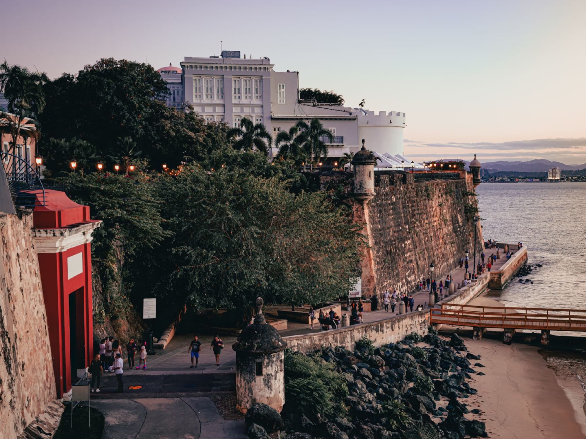 Scenic view of Old San Juan's coastal wall and paseo at sunset, Puerto Rico.