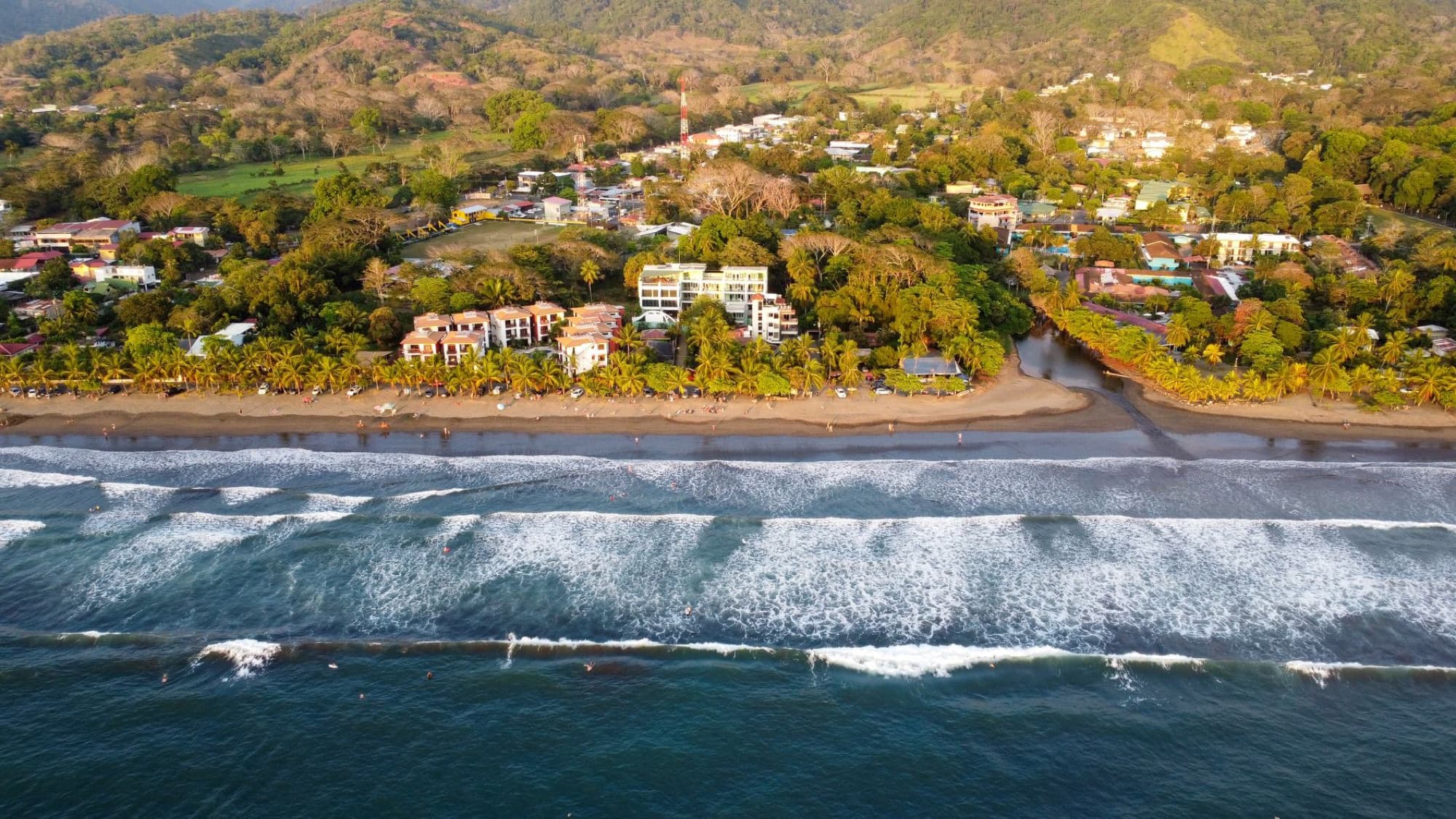 Stunning aerial view of Jaco Beach's coastline and townscape in Puntarenas, Costa Rica.