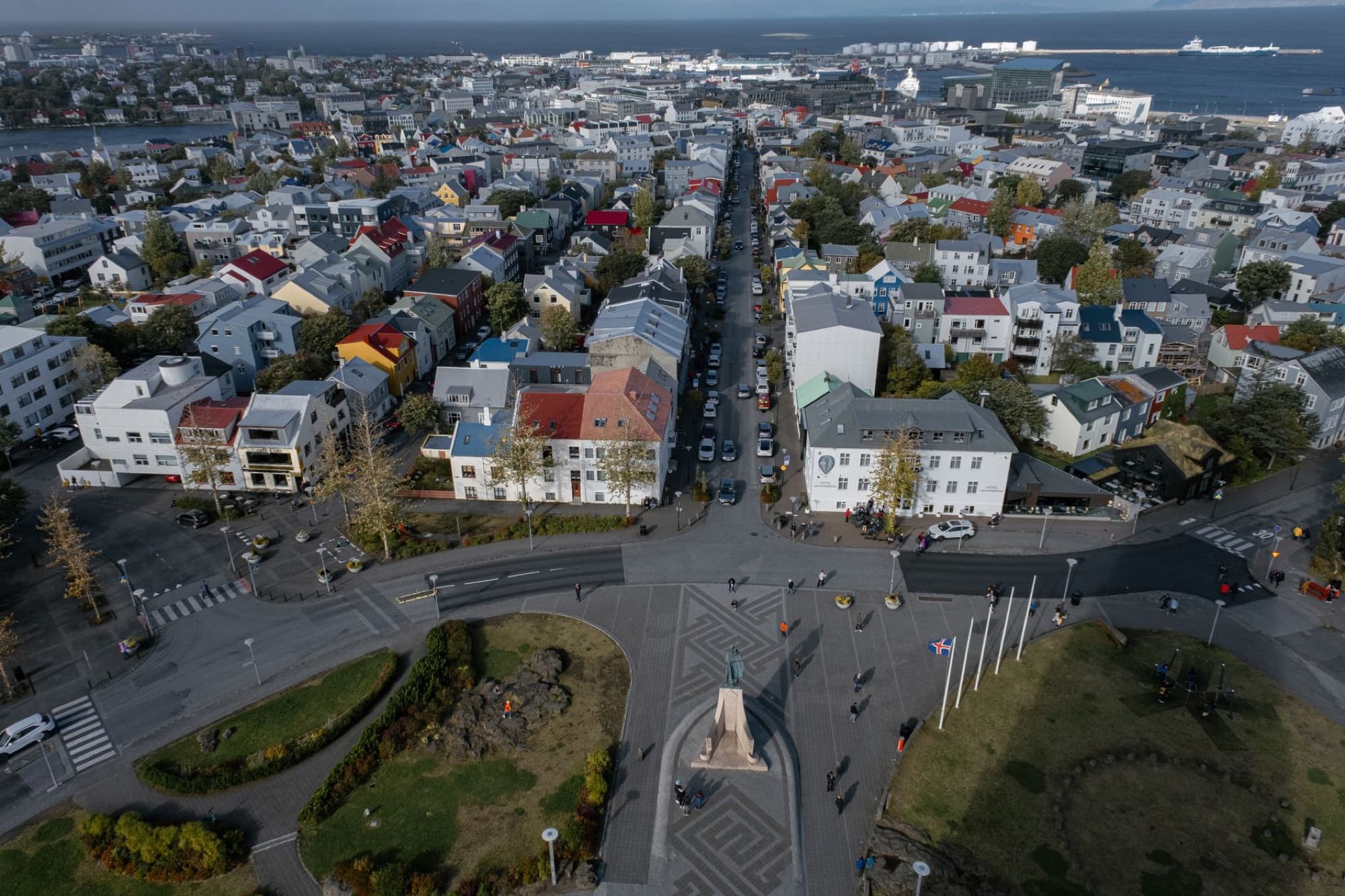 Panoramic aerial view of Reykjavik city with colorful houses and streets under a clear sky.