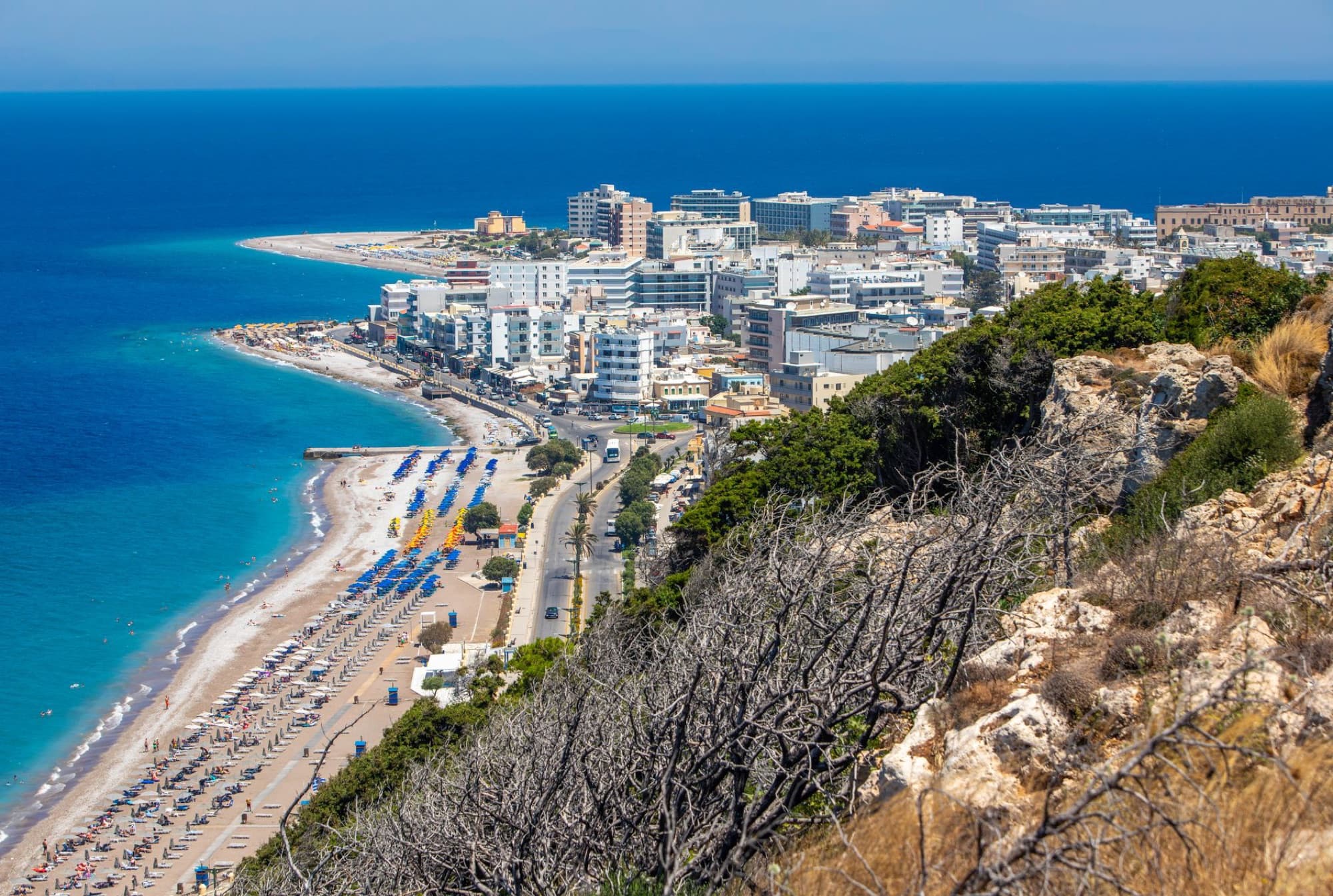 Scenic aerial view of a vibrant beachfront city in Rhodes, Greece, highlighting the summer coastline.