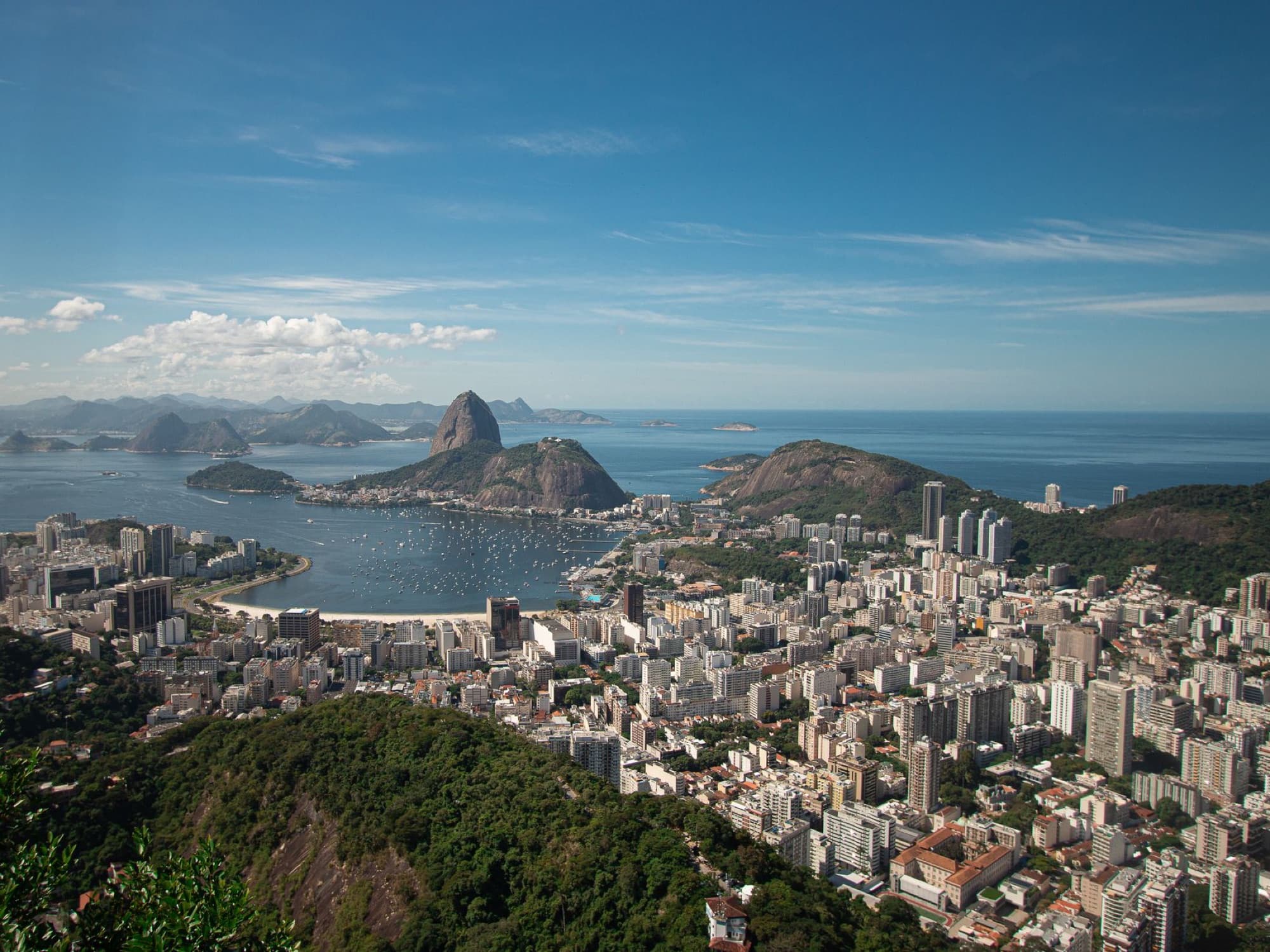 Discover the stunning aerial view of Rio de Janeiro's coastline featuring Sugarloaf Mountain and Guanabara Bay.