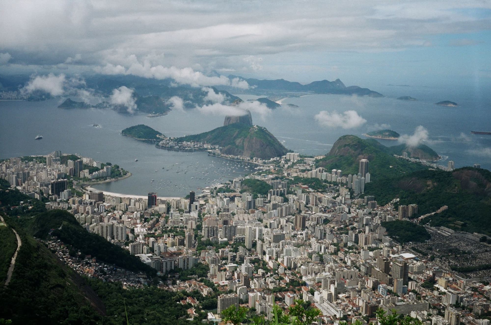 Aerial shot of Rio de Janeiro's skyline featuring Sugarloaf Mountain and Guanabara Bay.