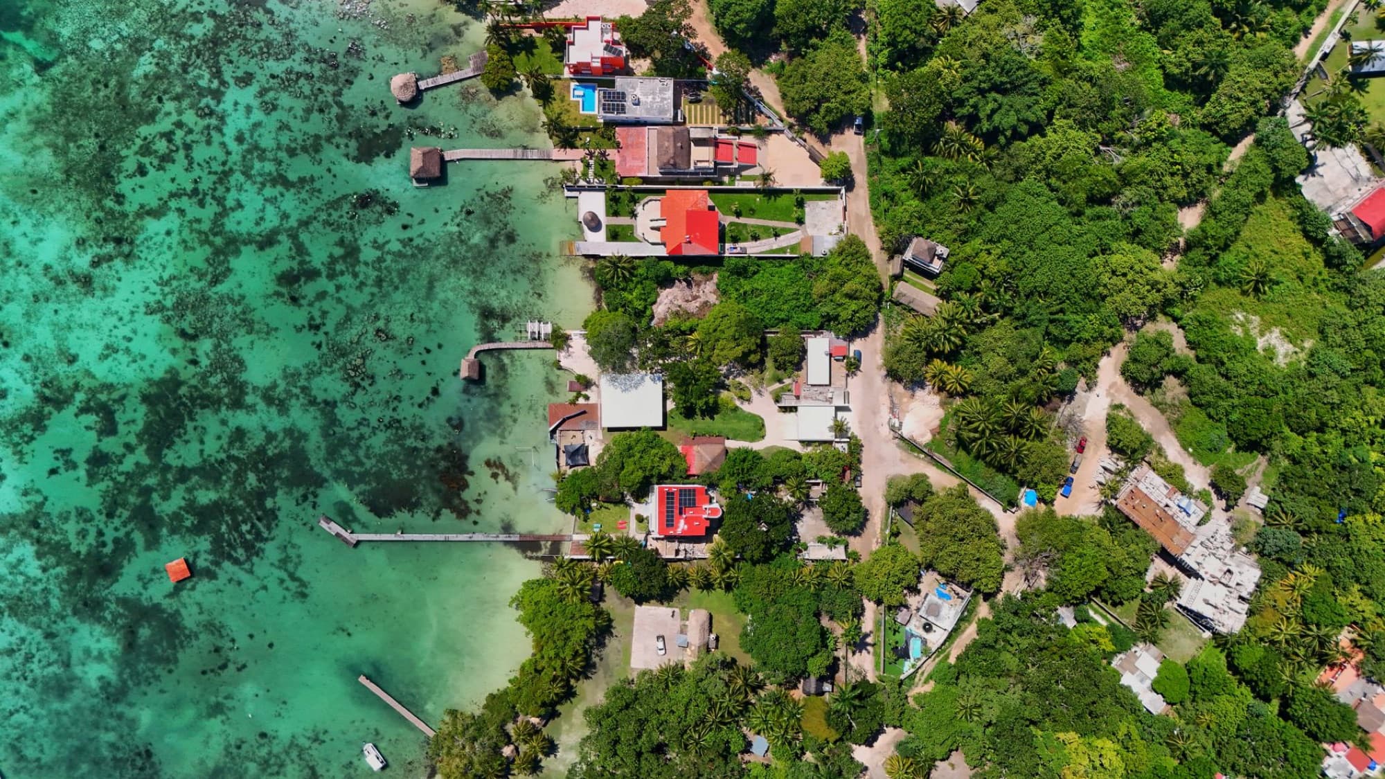 Aerial photograph showcasing a vivid coastal landscape with lush greenery and turquoise waters.